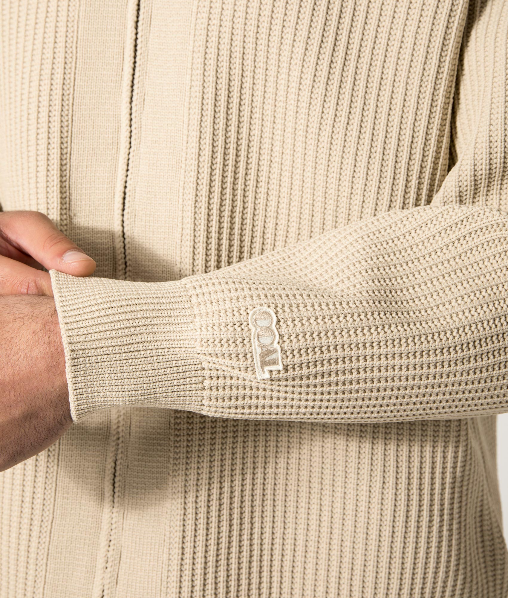 nanamica 5G Zip Through Cardigan in Ivory at EQVVS. Model Front Detail Shot.