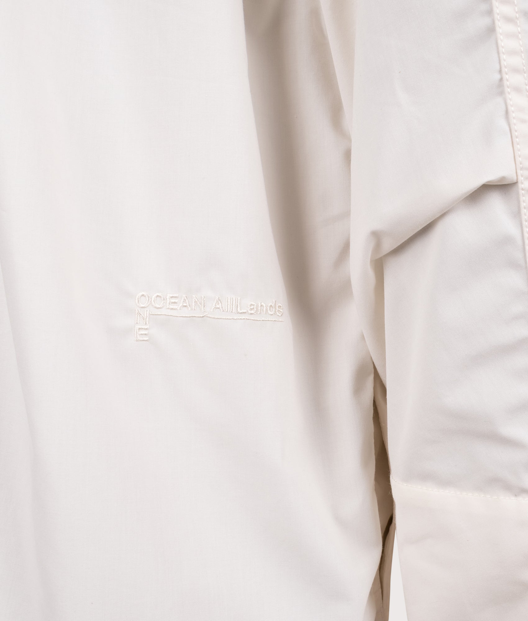 Nanamica Hooded Deck jacket in Off White at EQVVS Menswear. Detail shot.