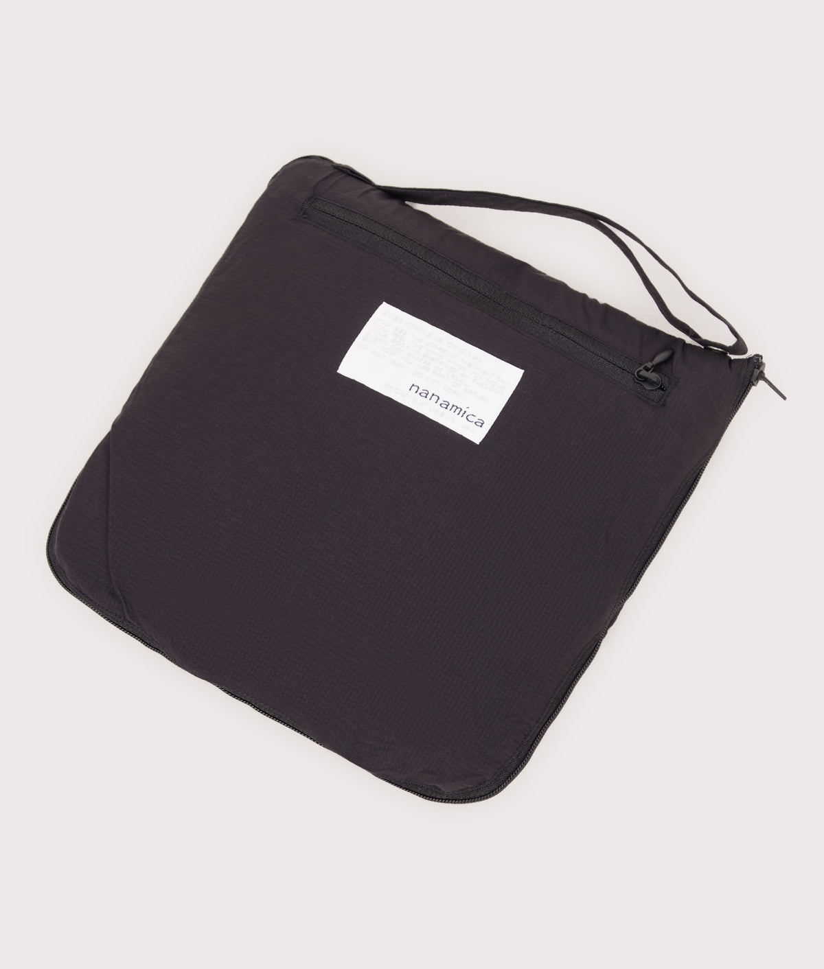 nanamica Packable Field Jacket in Black at EQVVS Menswear. Packed shot.