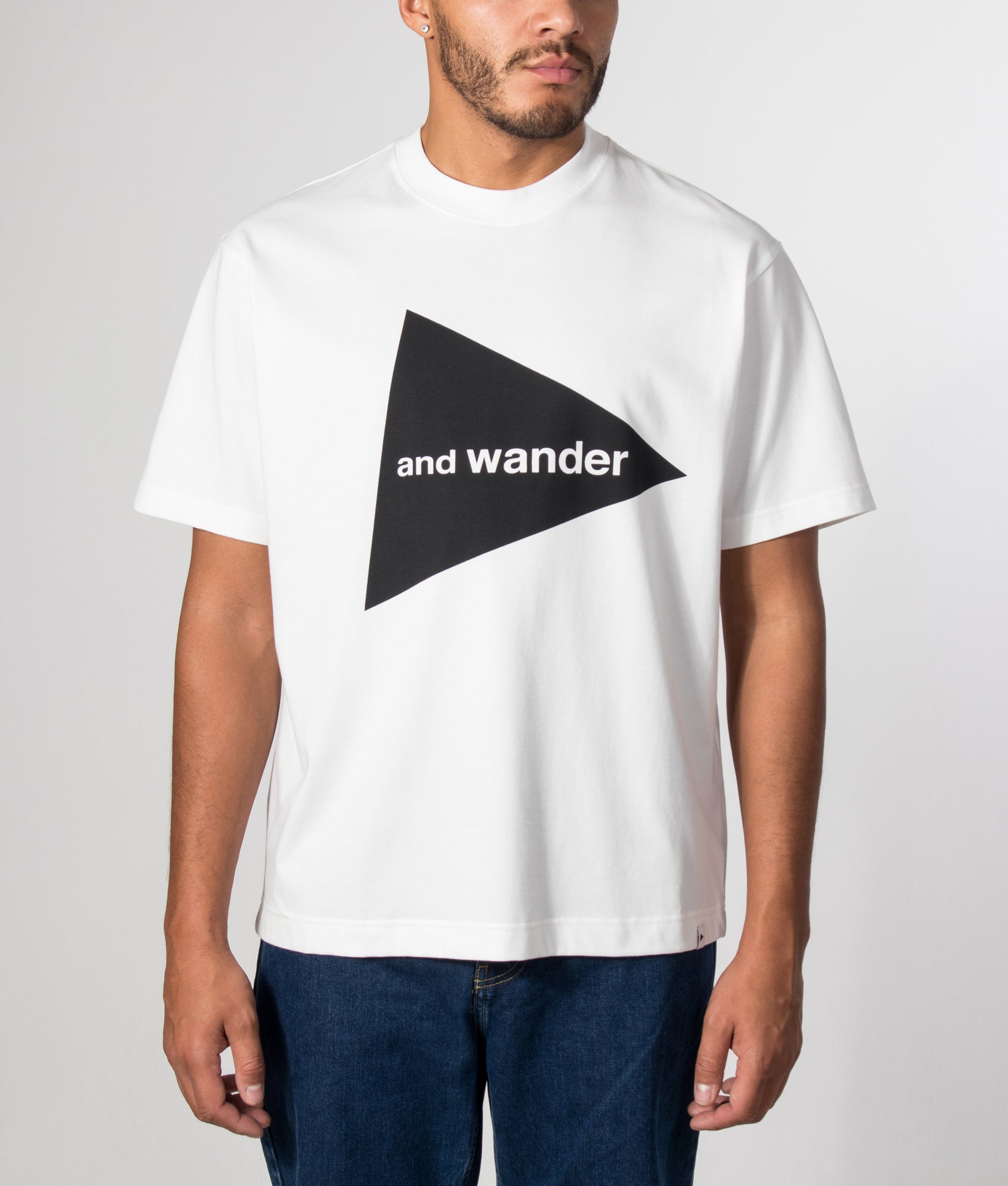 and wander Big Logo T-Shirt in White at EQVVS Menswear. Model front shot.