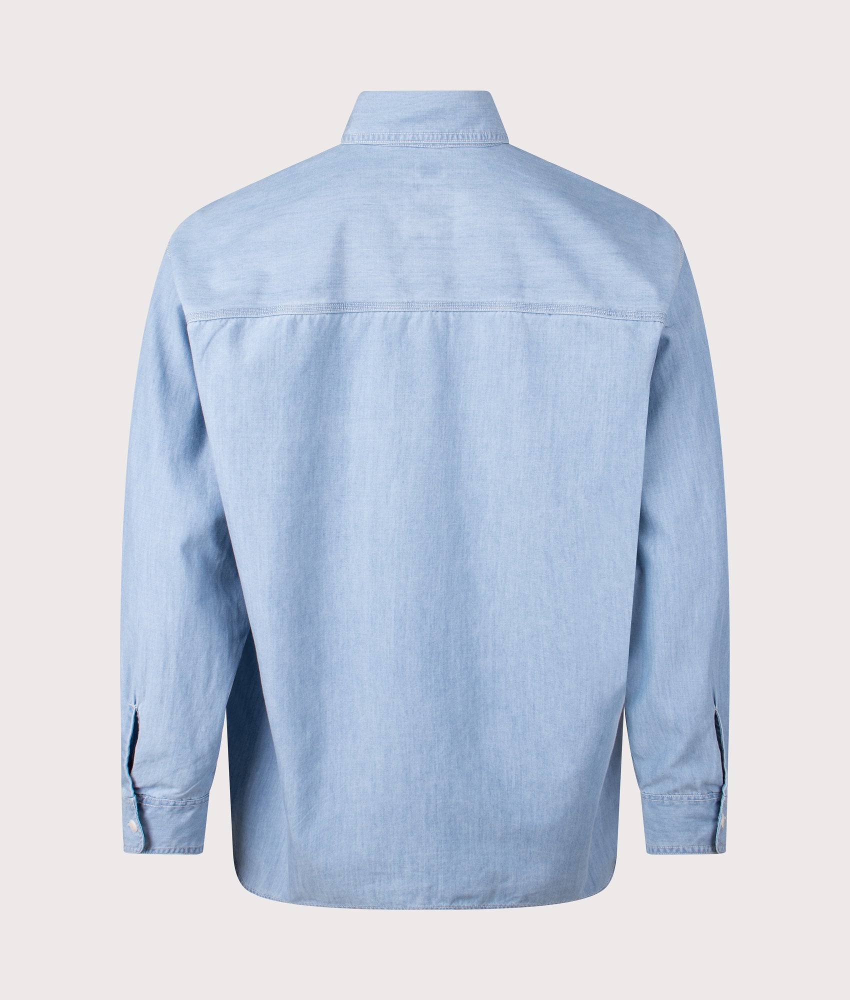 nanamica Oversized Regular Collar Chambray Shirt in Light Indigo at EQVVS Menswear. Back shot.
