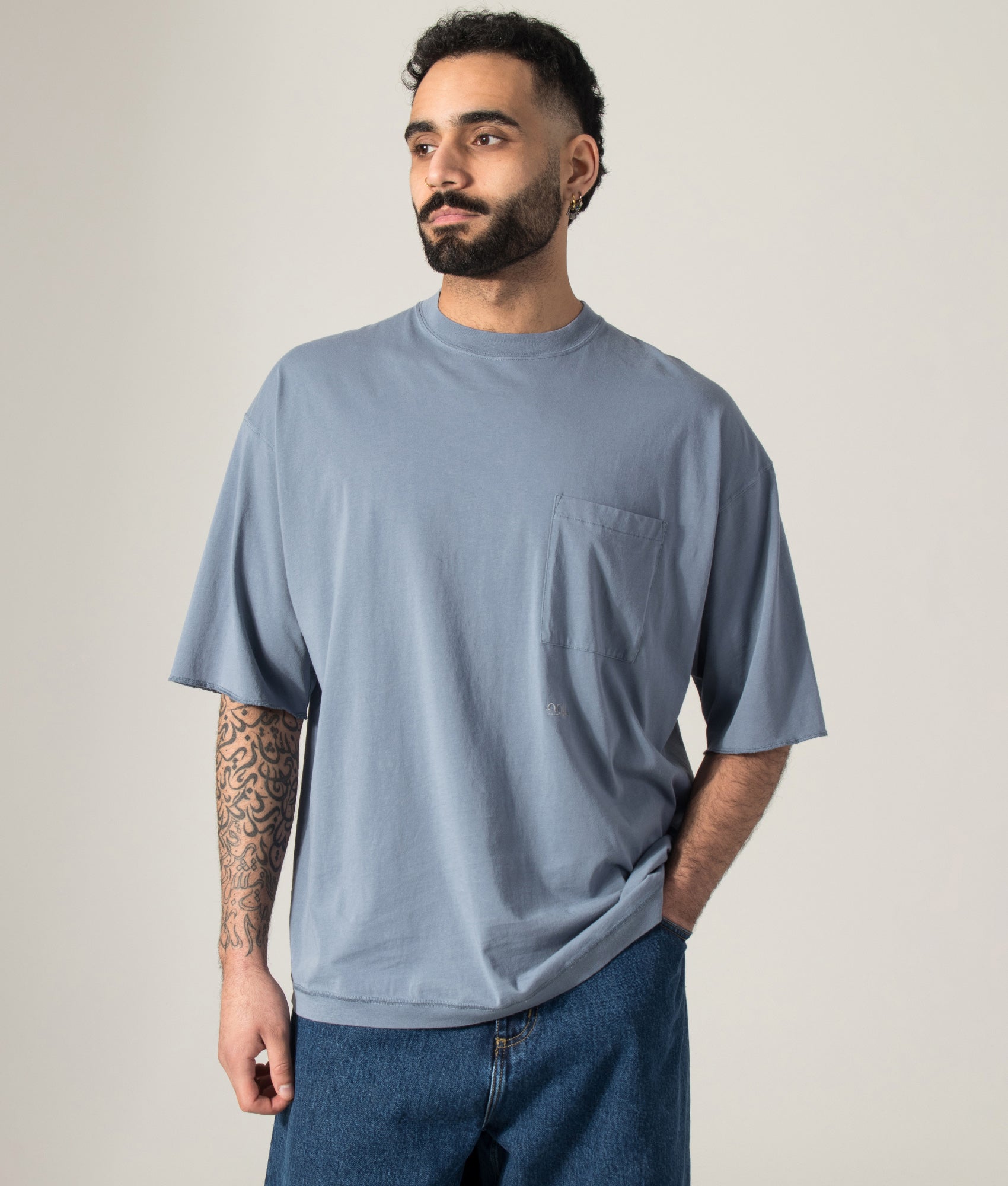 nanamica OOAL Pocket T-Shirt in Blue Gray at EQVVS Menswear. Model shot.