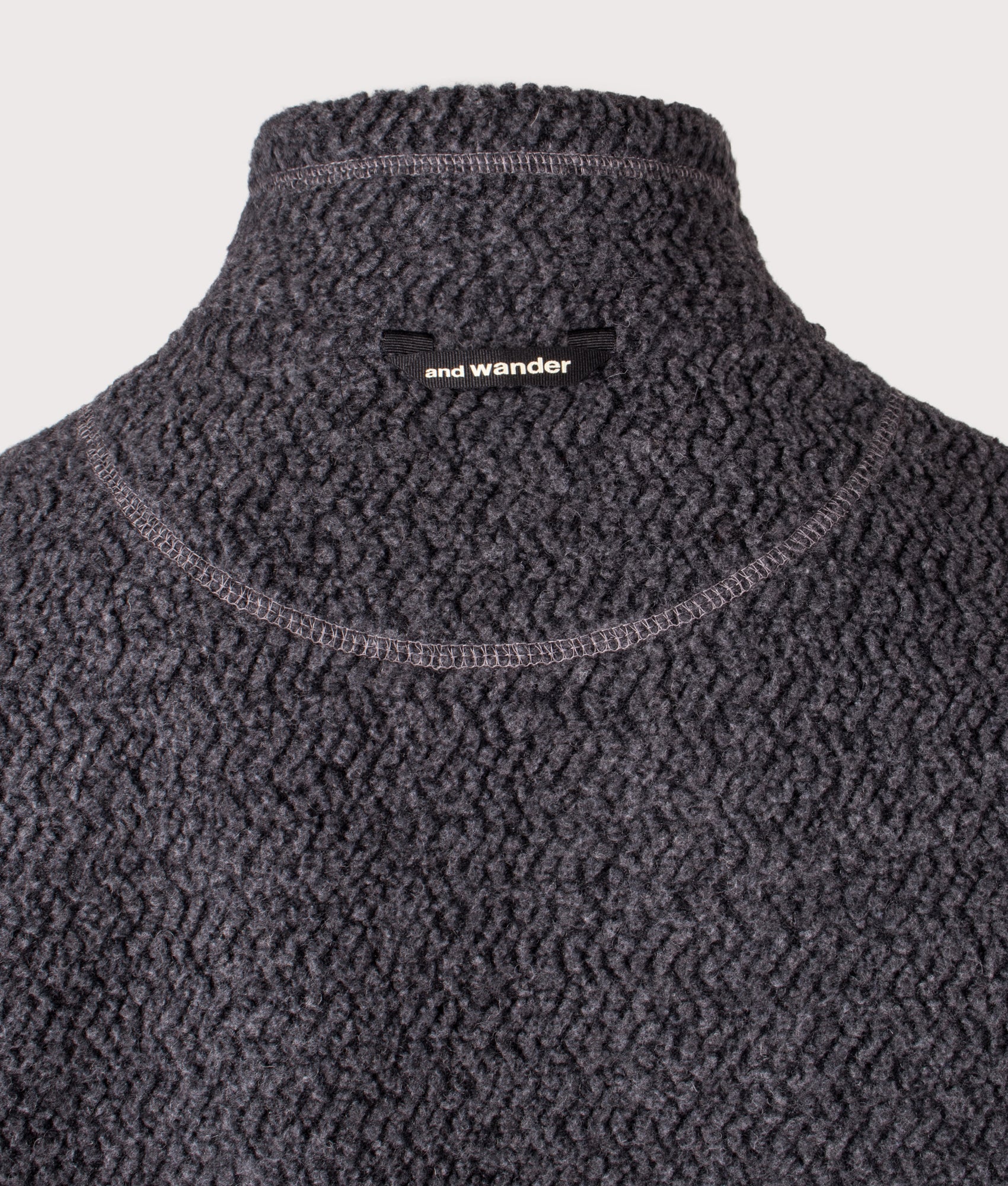 and wander Re Wool JQ Stand Zip Sweatshirt in Charcoal at EQVVS Menswear. Back detail shot.