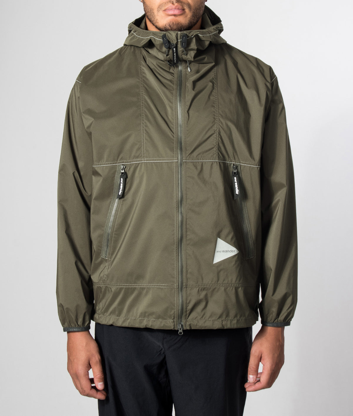 and wander Regular Fit Pertex Wind Jacket in Dark Khaki at EQVVS Menswear. Model front shot.
