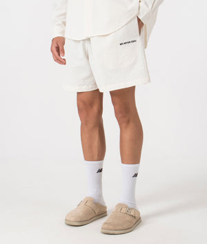 MKI Relaxed Fit Seersucker Shorts in Off White. Side angle model shot at EQVVS.