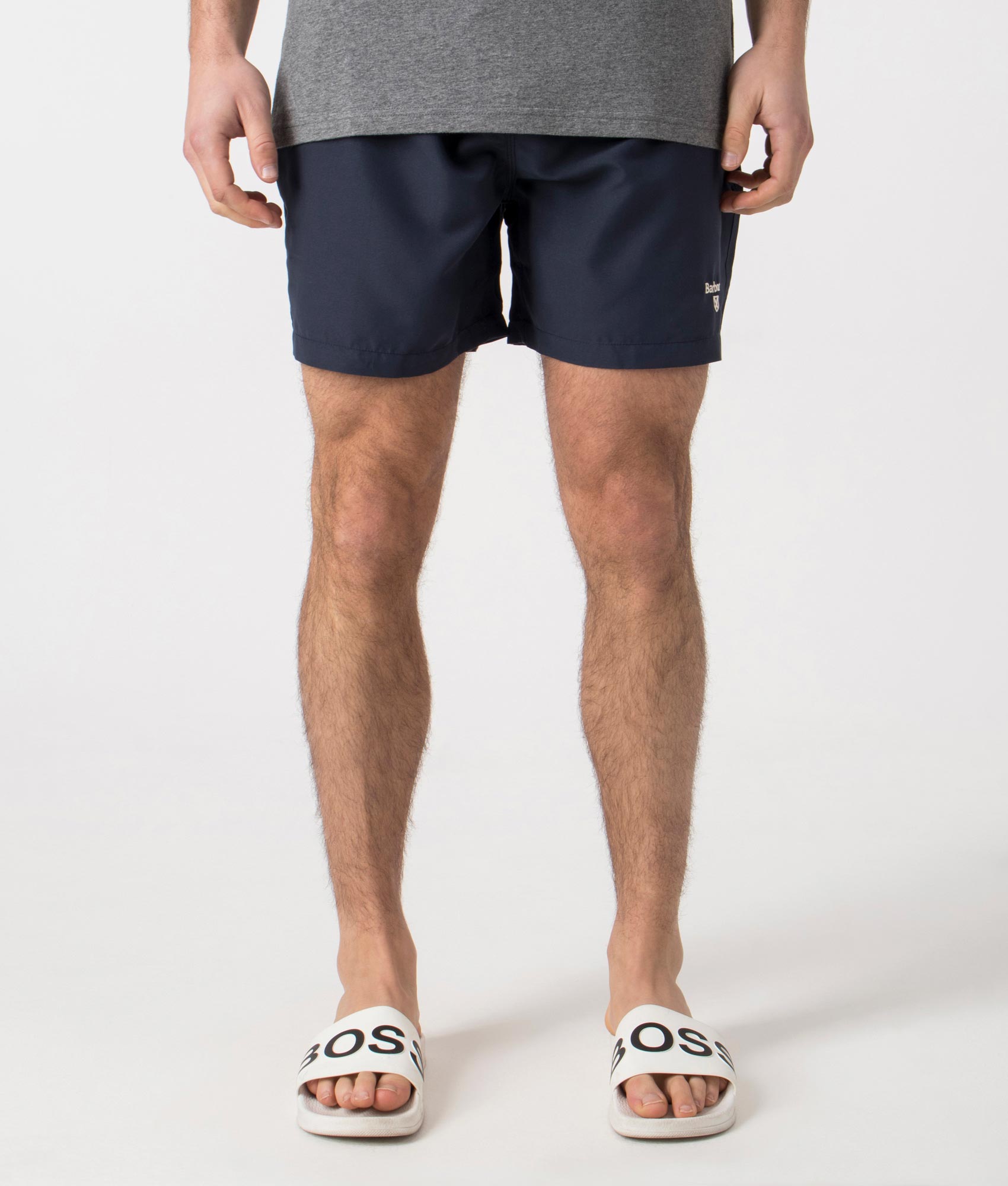 Barbour Staple Logo 5" Swim Shorts in Navy at EQVVS Menswear. Model front shot.