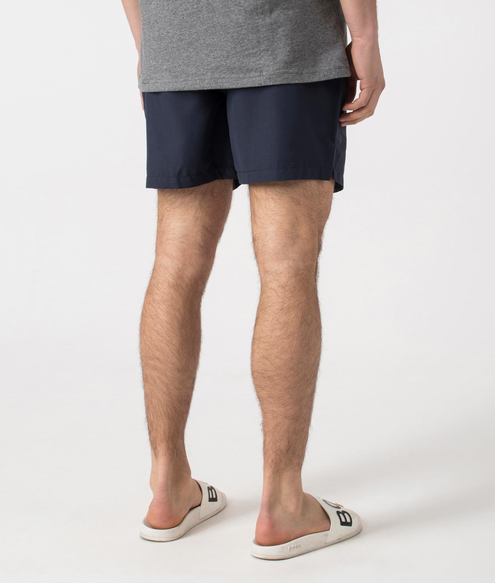 Barbour Staple Logo 5" Swim Shorts in Navy at EQVVS Menswear. Angled model back shot.