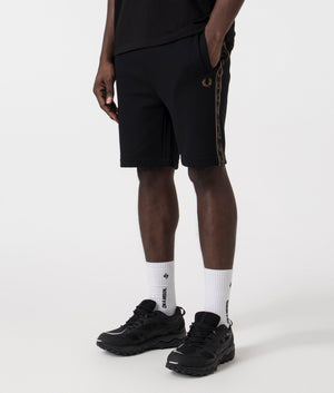 Fred Perry Taped Sweat Short in Black/Warm Stone with side taping detail.  Side angle shot at EQVVS.