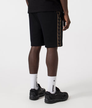 Fred Perry Taped Sweat Short in Black/Warm Stone with side taping detail.  Back angle shot at EQVVS.