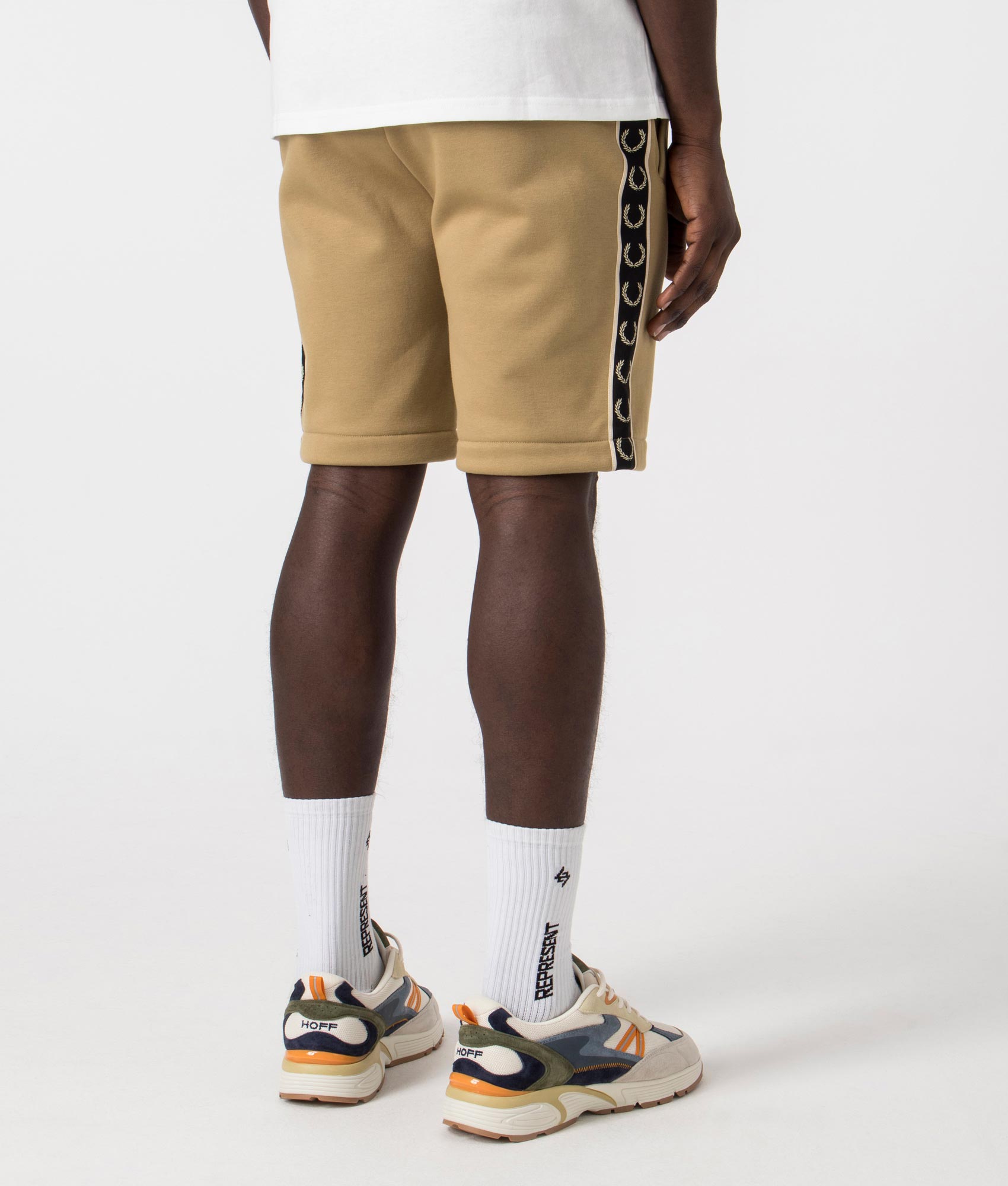 Fred Perry Taped Sweat Short in Warm Stone/Oatmeal with side taping detail. Back angle shot at EQVVS.
