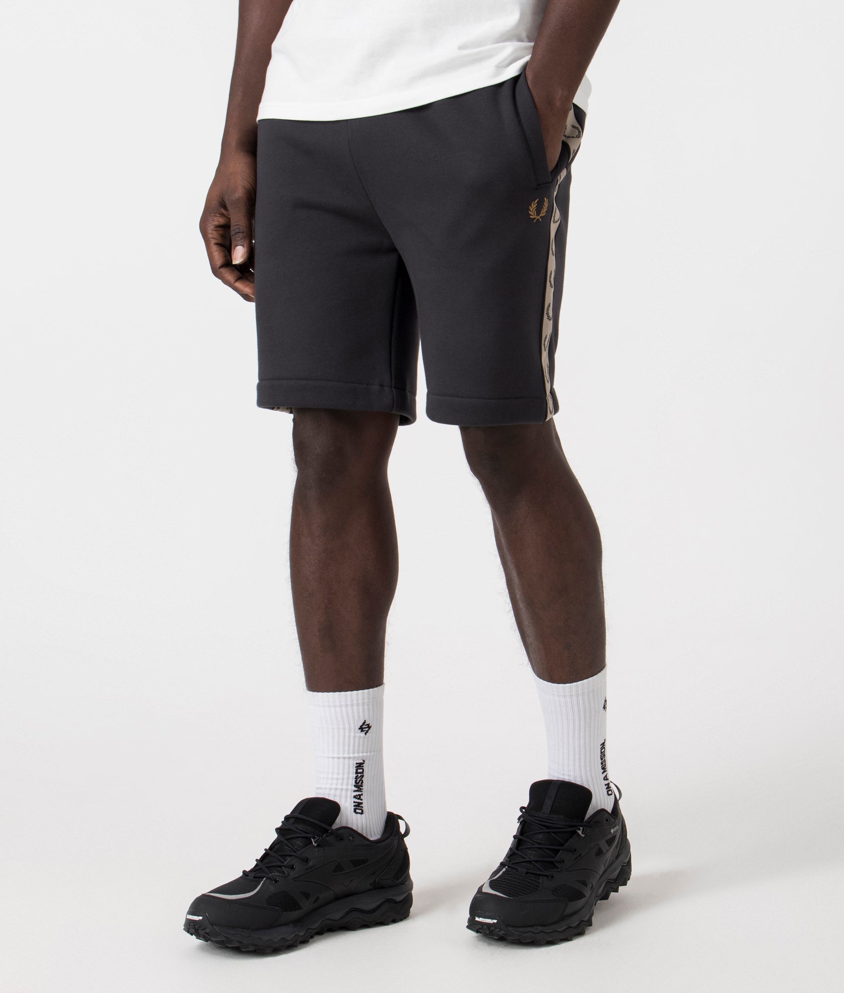 Fred Perry Taped Sweat Short in Anchor Grey/Black with side taping detail. Side angle shot at EQVVS.