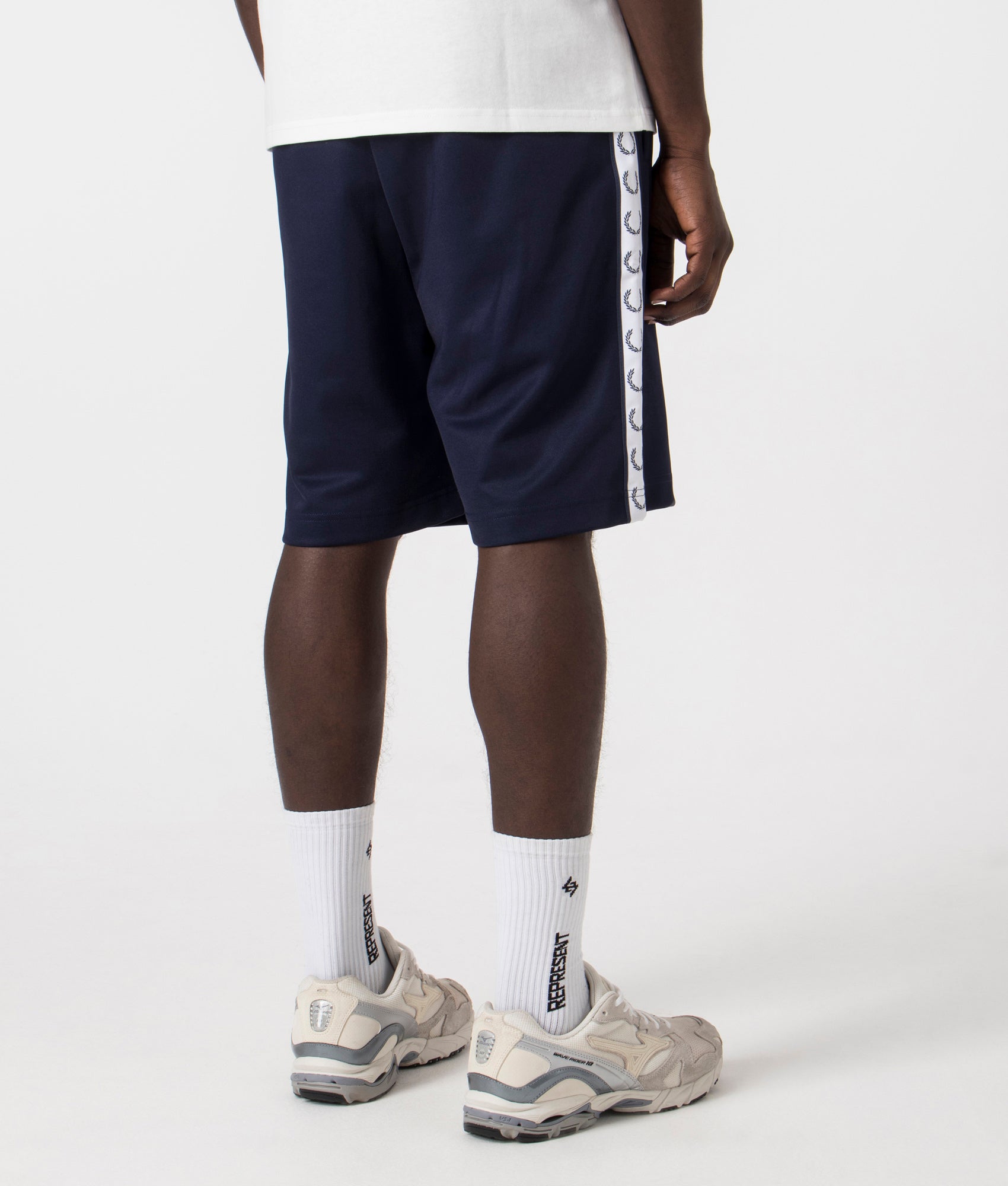 Fred Perry Taped Sweat Short in Carbon Blue with side taping detail. Back angle shot at EQVVS.