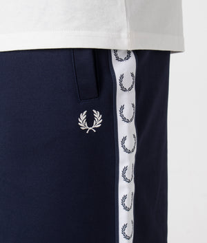 Fred Perry Taped Sweat Short in Carbon Blue with side taping detail. Detail shot at EQVVS.