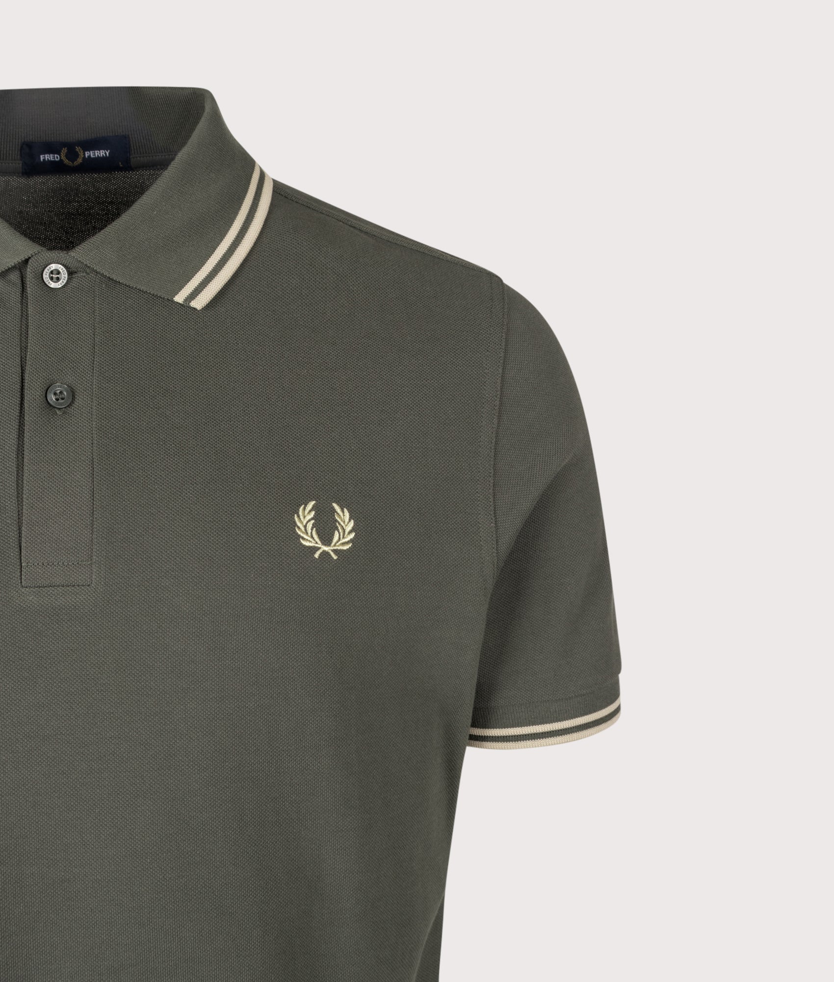 Fred Perry Twin Tipped Polo Shirt in Field Green and Oatmeal at EQVVS Menswear. Detail shot.