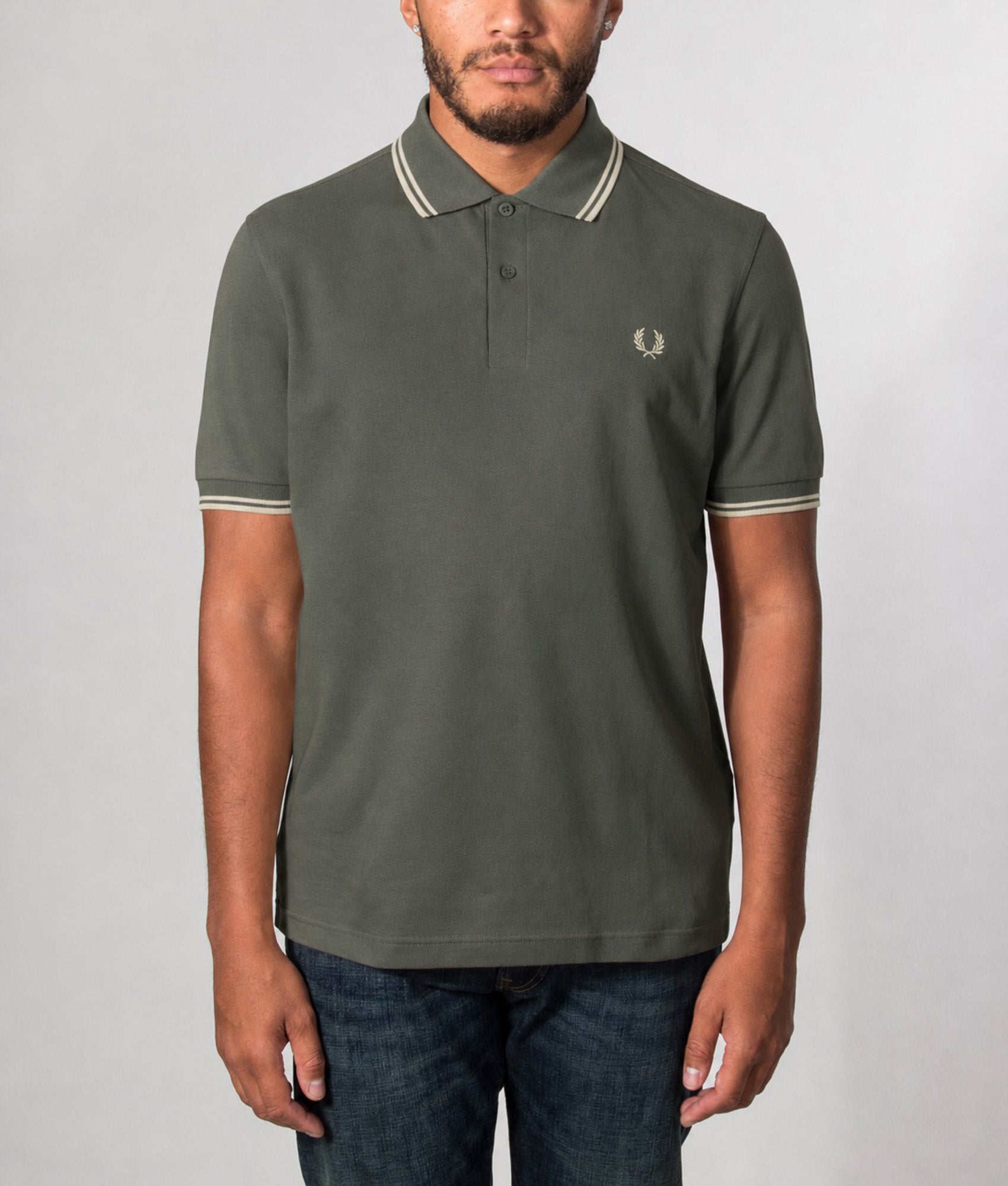 Fred Perry Twin Tipped Polo Shirt in Field Green and Oatmeal at EQVVS Menswear. Model front shot.