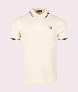 Twin Tipped Fred Perry Polo Shirt in Ice Cream and French Navy. EQVVS Front Angle Shot.