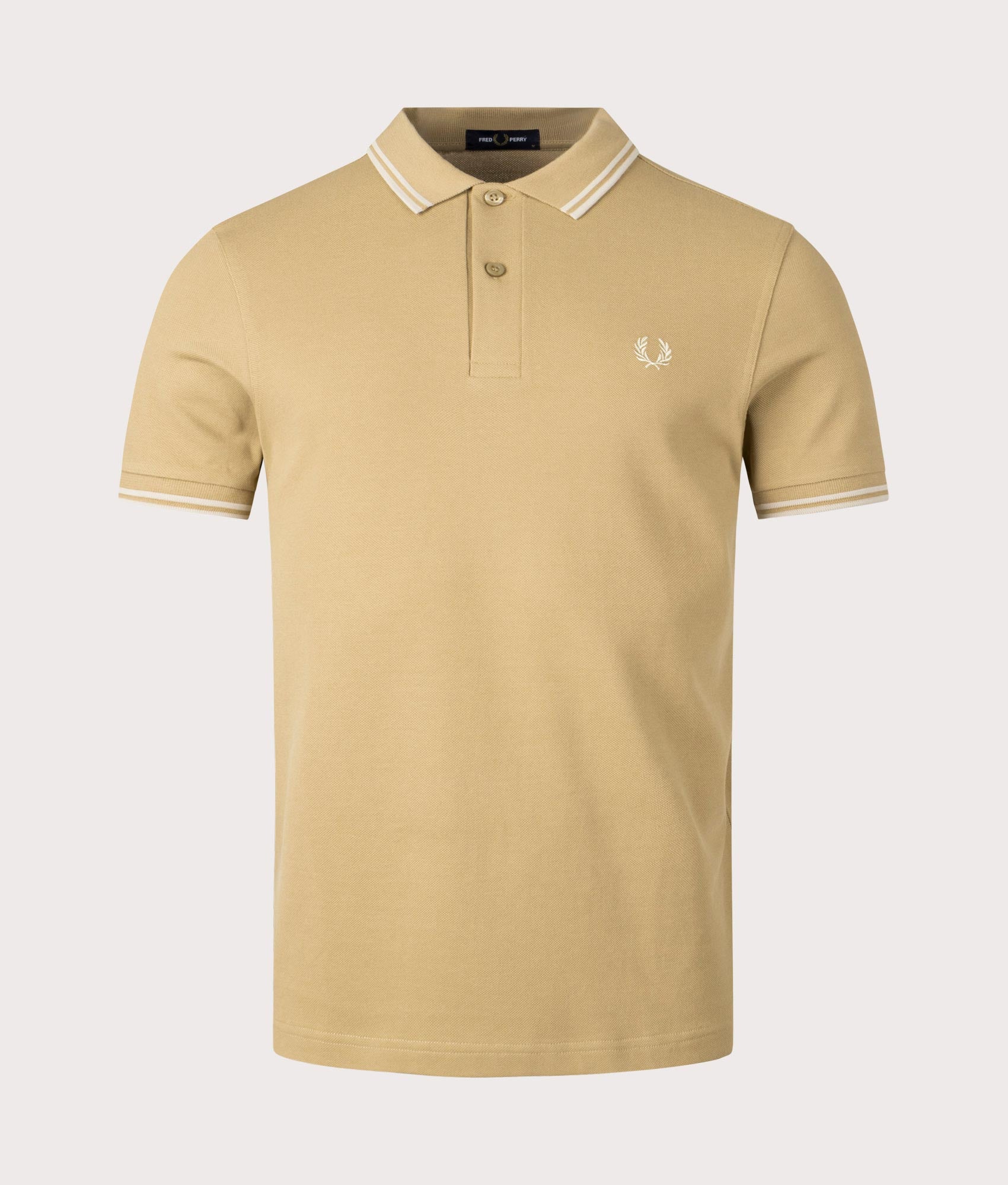 Twin Tipped Fred Perry Polo Shirt in Warm Stone and Oatmeal beige by Fred Perry. EQVVS Front Angle Shot.