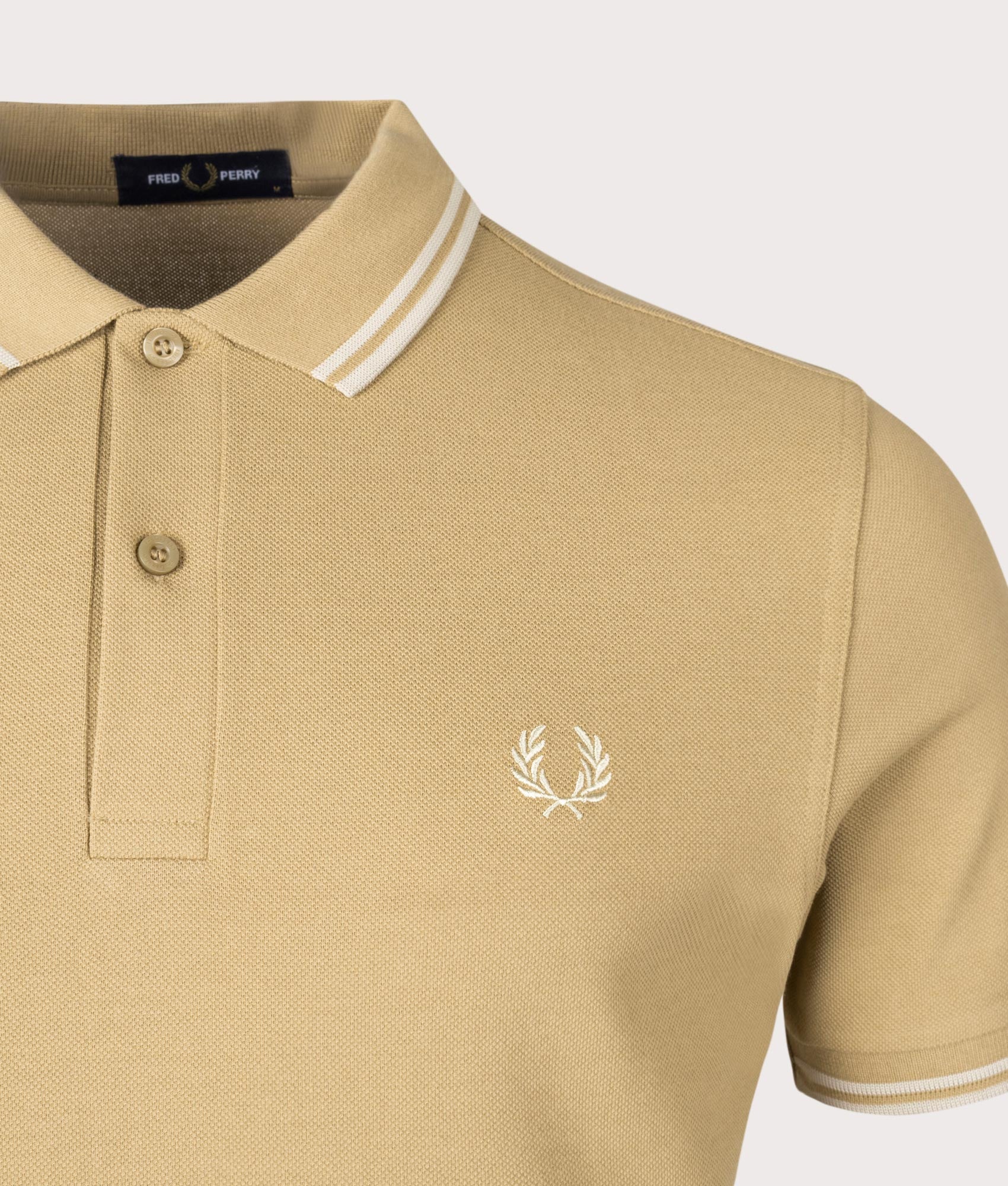 Twin Tipped Fred Perry Polo Shirt in Warm Stone and Oatmeal beige by Fred Perry. EQVVS Detail Shot.
