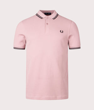 Twin Tipped Fred Perry Polo Shirt in Dusty Rose Pink. EQVVS Front Angle Shot.