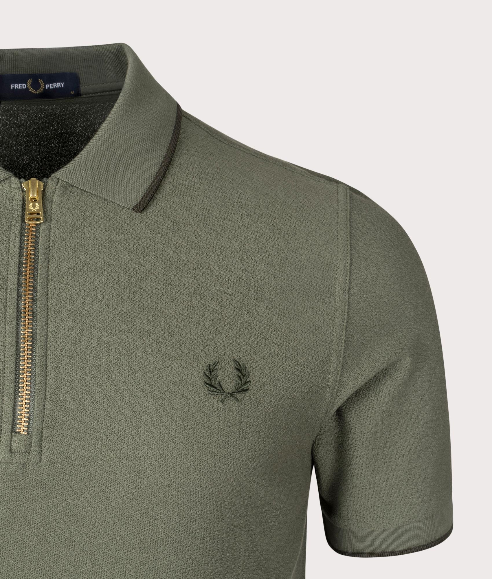 Crepe Pique Zip Neck Polo Shirt in Laurel Wreath Green by Fred Perry. EQVVS Shot.