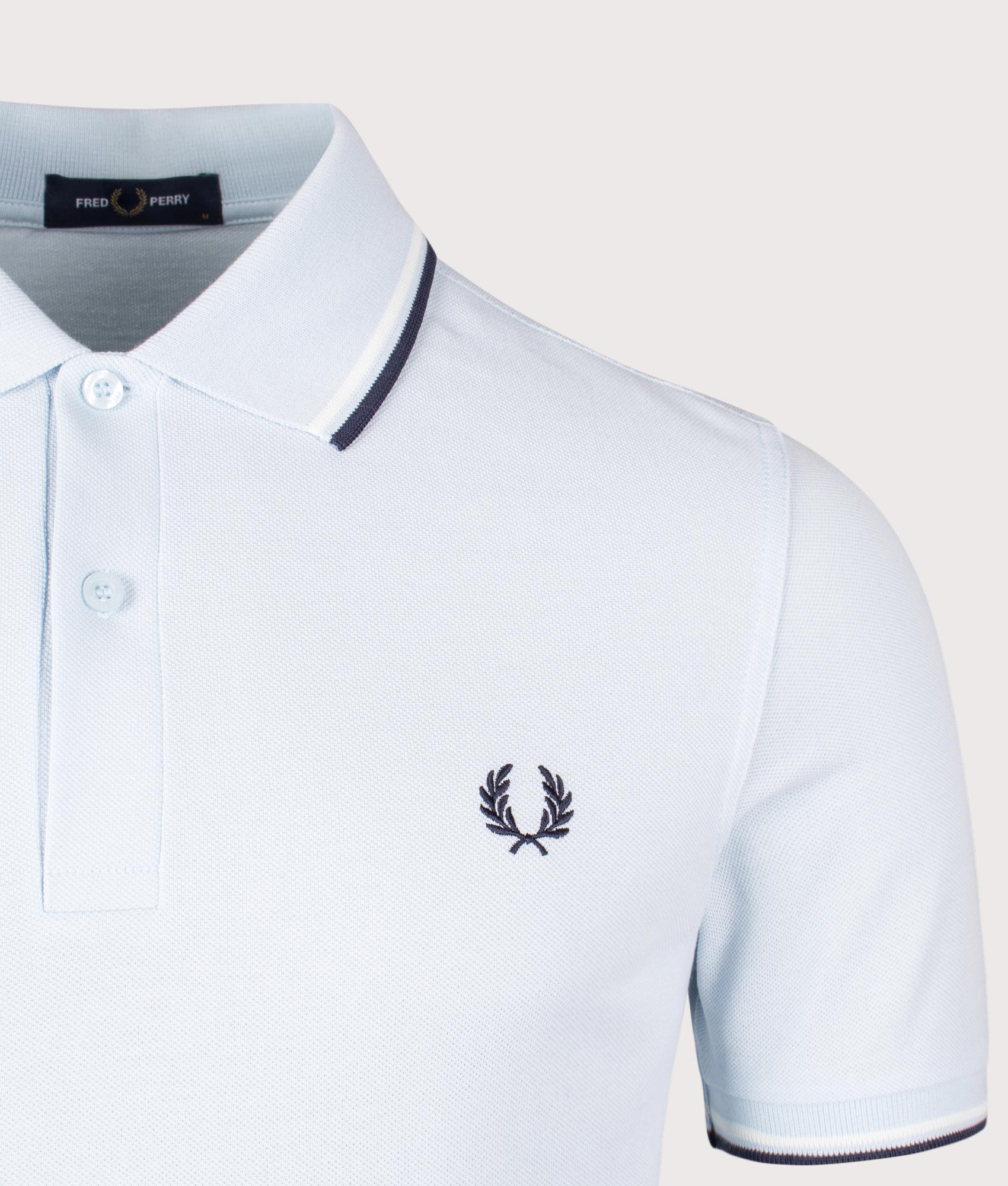 Fred Perry Twin Tipped Polo Shirt in Light Ice/Snow White/Tennis Blue. Shot at EQVVS. Detail shot. 