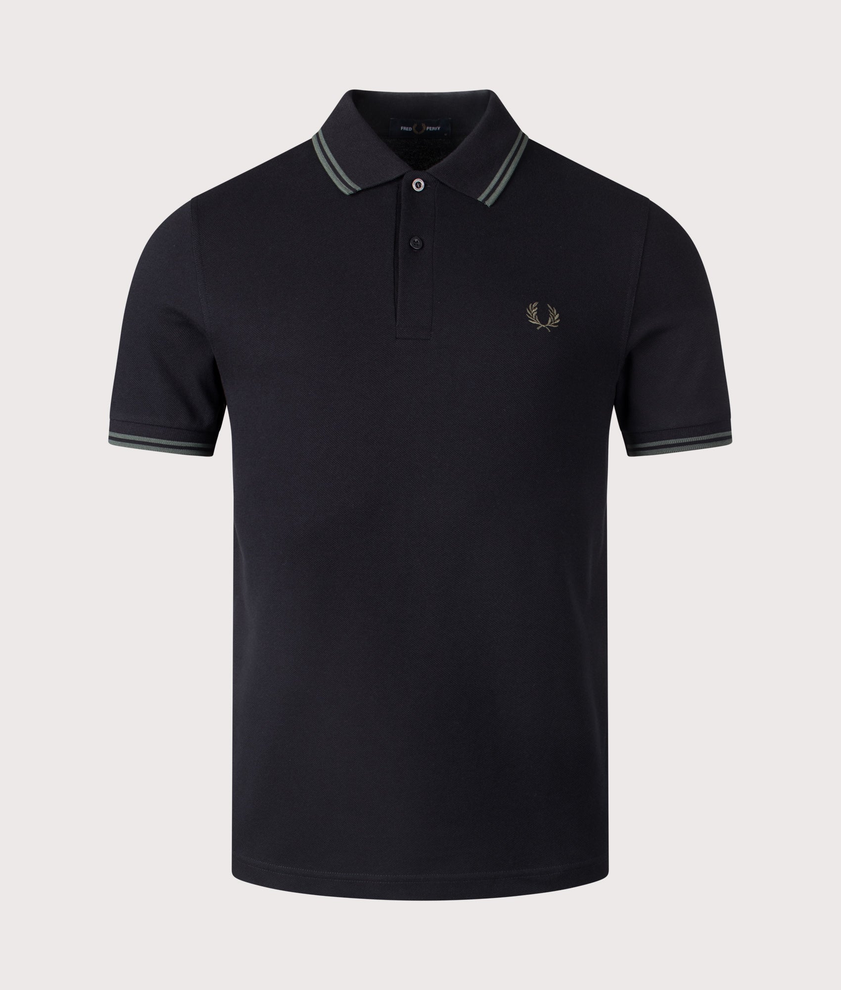 Twin Tipped Polo Shirt in black by Fred Perry. Shot at EQVVS. Front shot. 