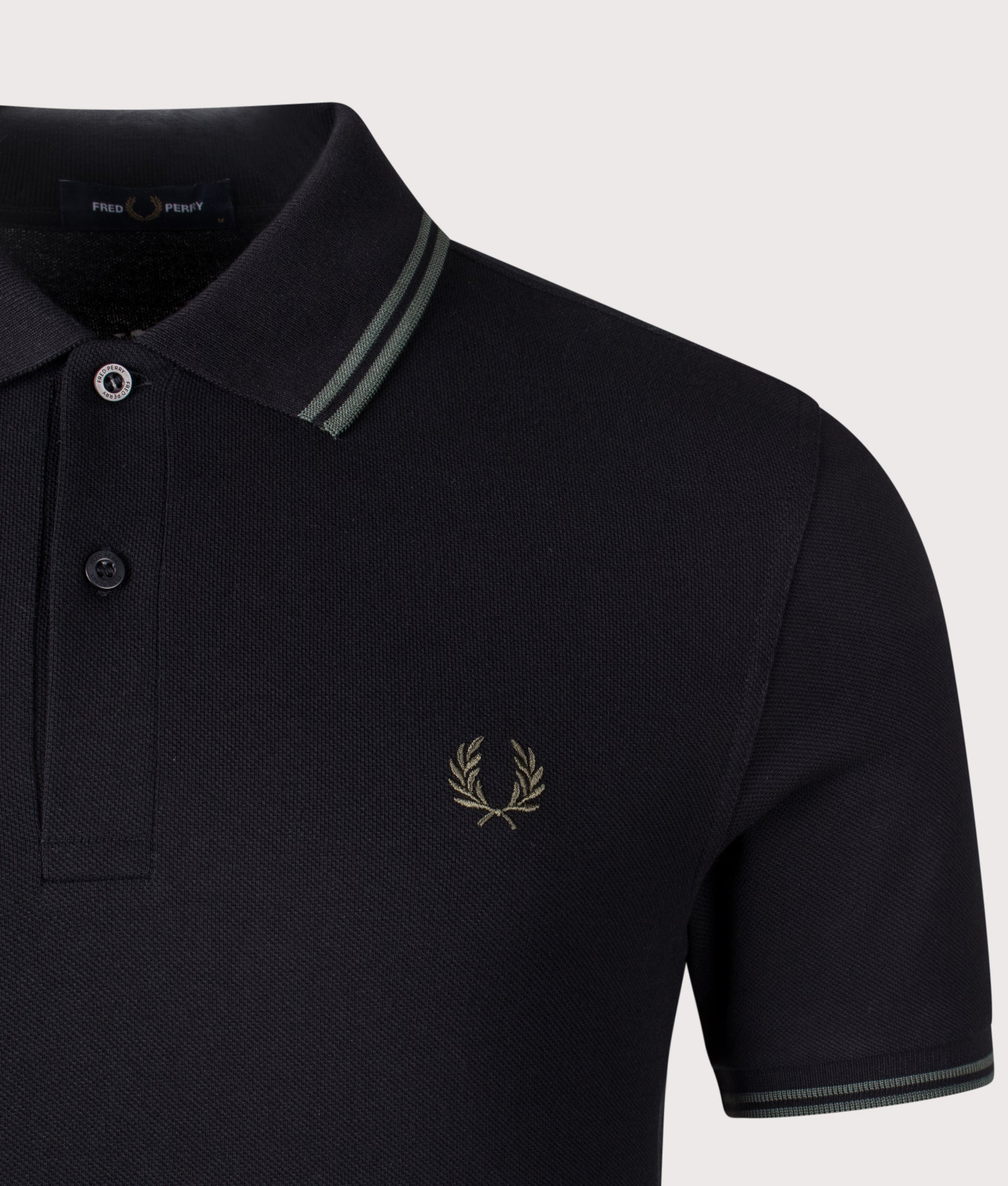 Twin Tipped Polo Shirt in black by Fred Perry. Shot at EQVVS. Detail shot.