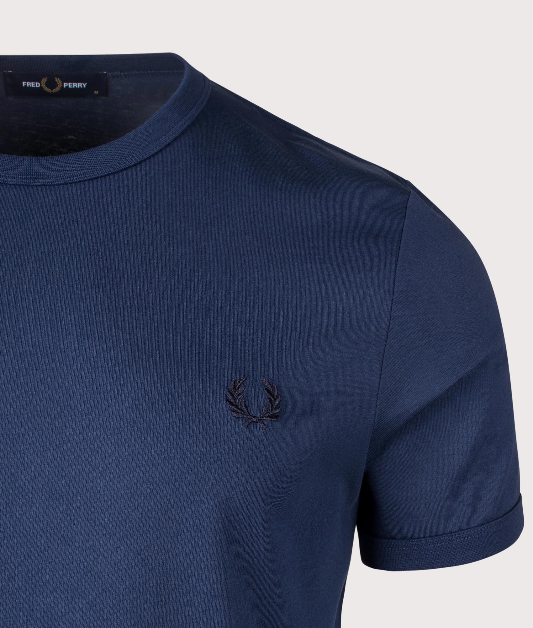 Fred Perry Ringer T-Shirt in Tennis Blue. Shot at EQVVS.  Detail shot. 