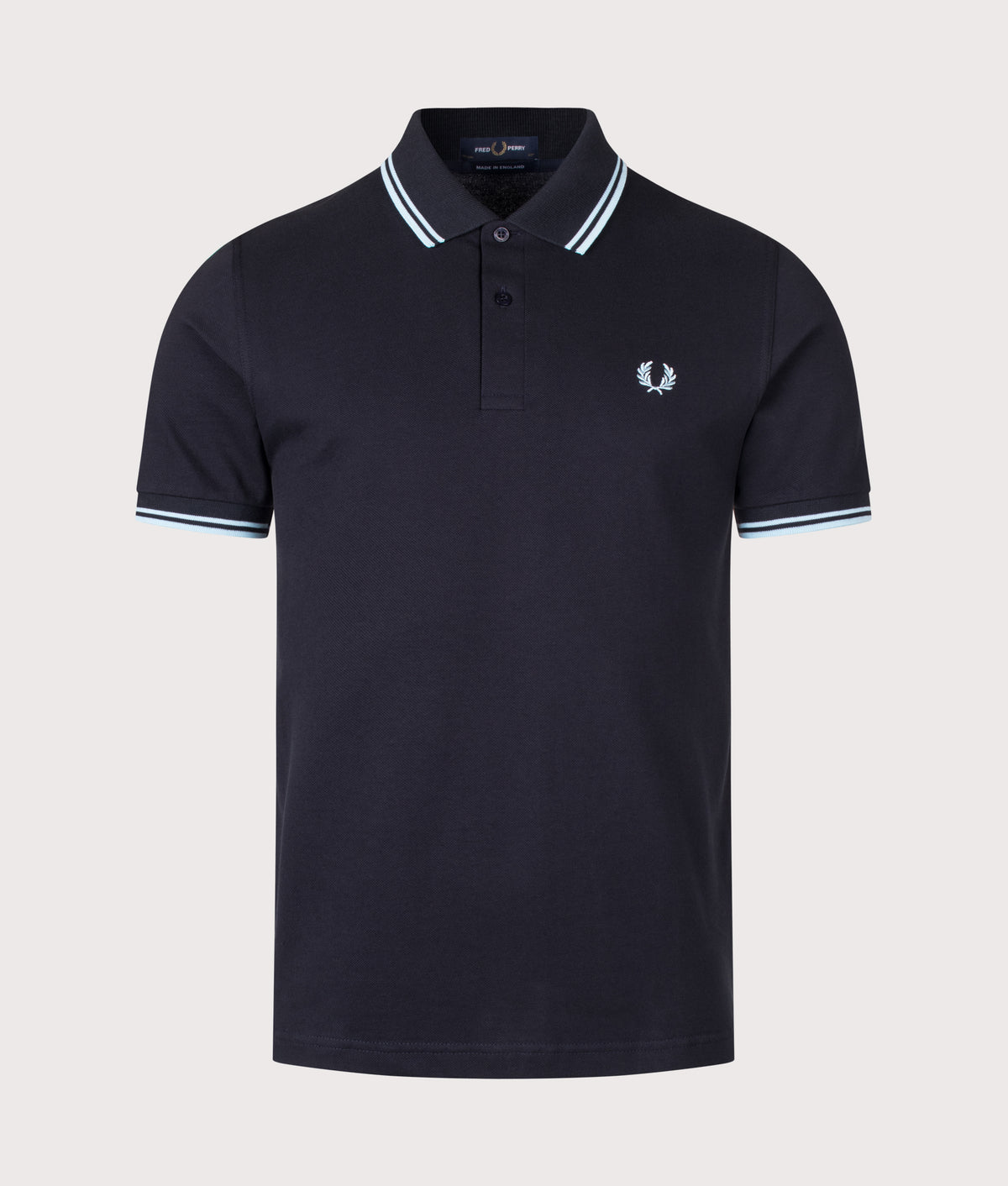 Fred Perry M12 Regular Fit 'Made in England' Twin Tipped Fred Perry Polo Shirt in Navy at EQVVS Menswear. Front shot.