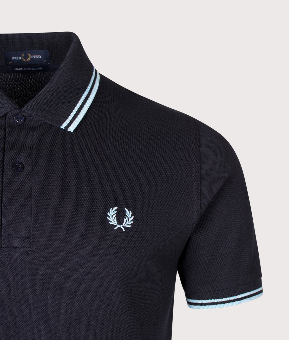 Fred Perry M12 Regular Fit 'Made in England' Twin Tipped Fred Perry Polo Shirt in Navy at EQVVS Menswear. Detail shot.