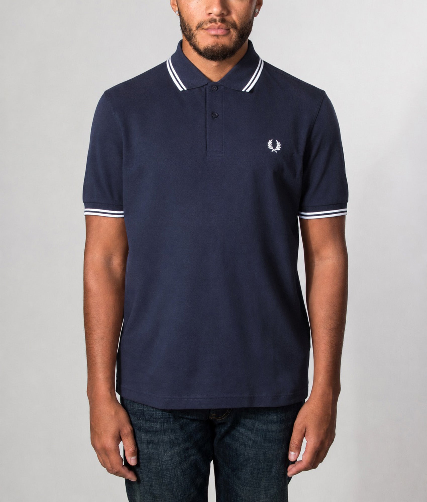 Fred Perry Twin Tipped Polo Shirt in Navy and White at EQVVS Menswear. Model front shot.