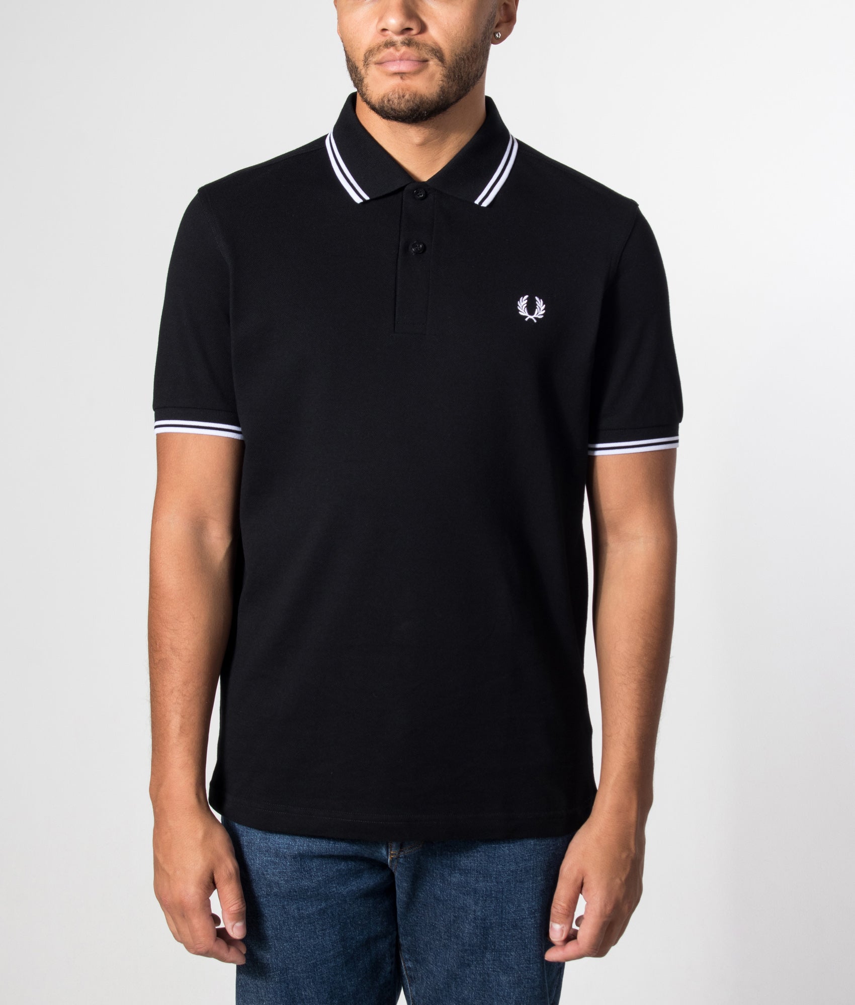 Fred Perry Twin Tipped Fred Perry Polo Shirt in Black at EQVVS Menswear. Model front shot.