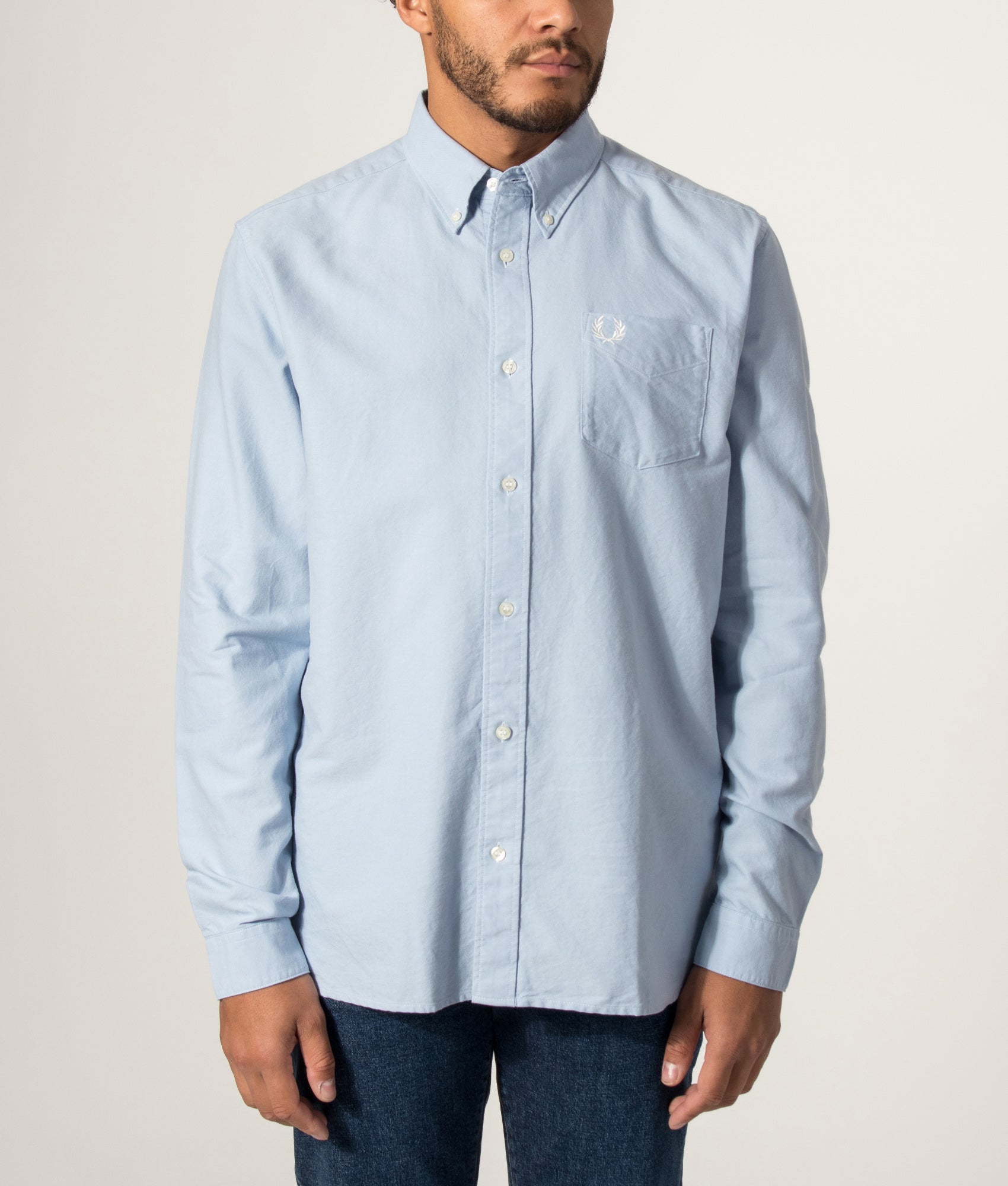 Fred Perry Oxford Shirt in Light Smoke Blue at EQVVS Menswear. Model front shot.