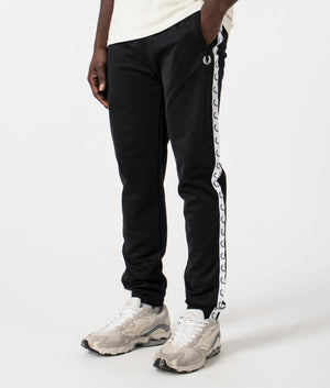 Track Pants in Black by Fred Perry. EQVVS Side Angle Shot.