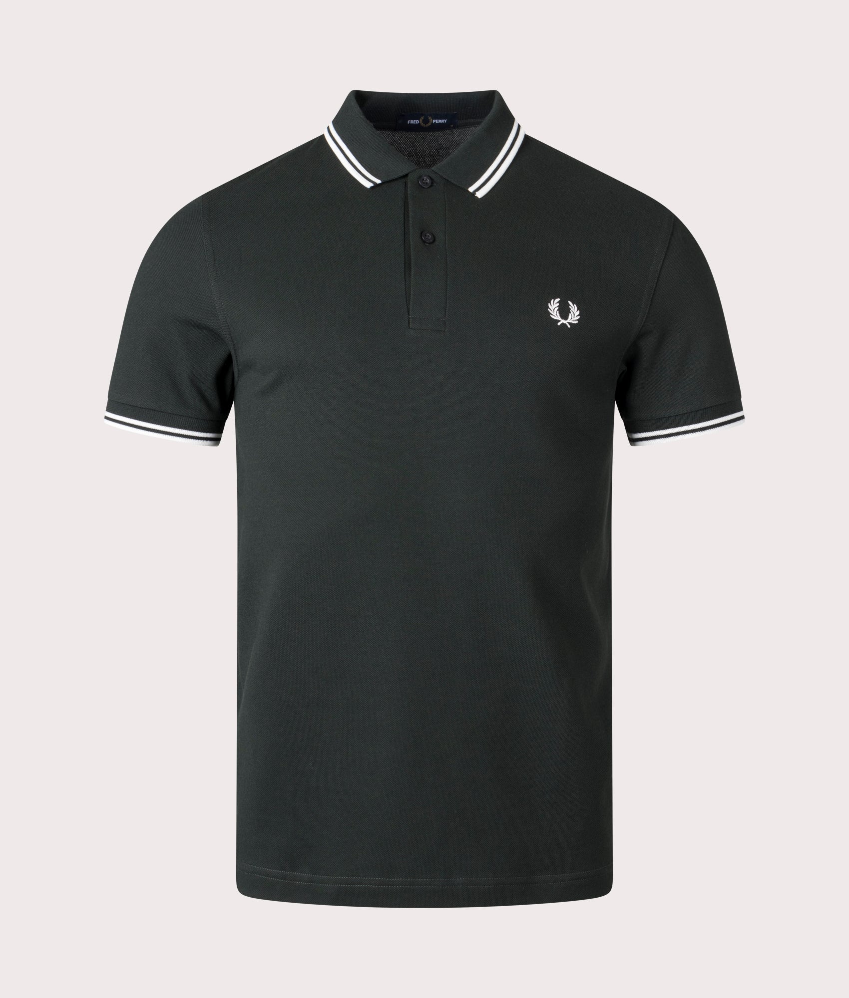 Fred Perry Twin Tipped Polo Shirt in Night Green and Snow White at EQVVS Menswear. Front shot. 