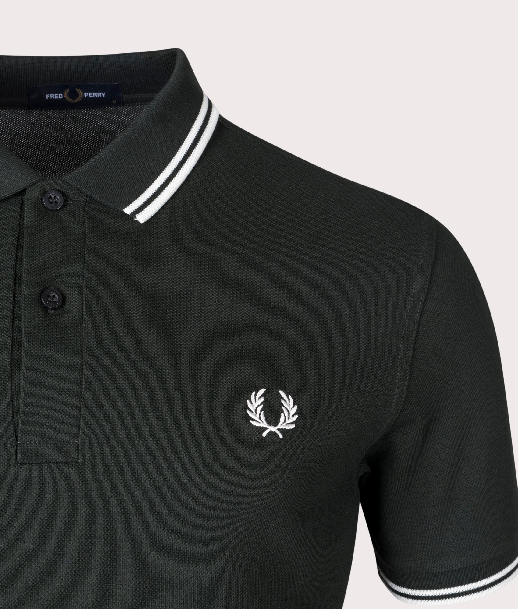 Fred Perry Twin Tipped Polo Shirt in Night Green and Snow White at EQVVS Menswear. Detail shot.