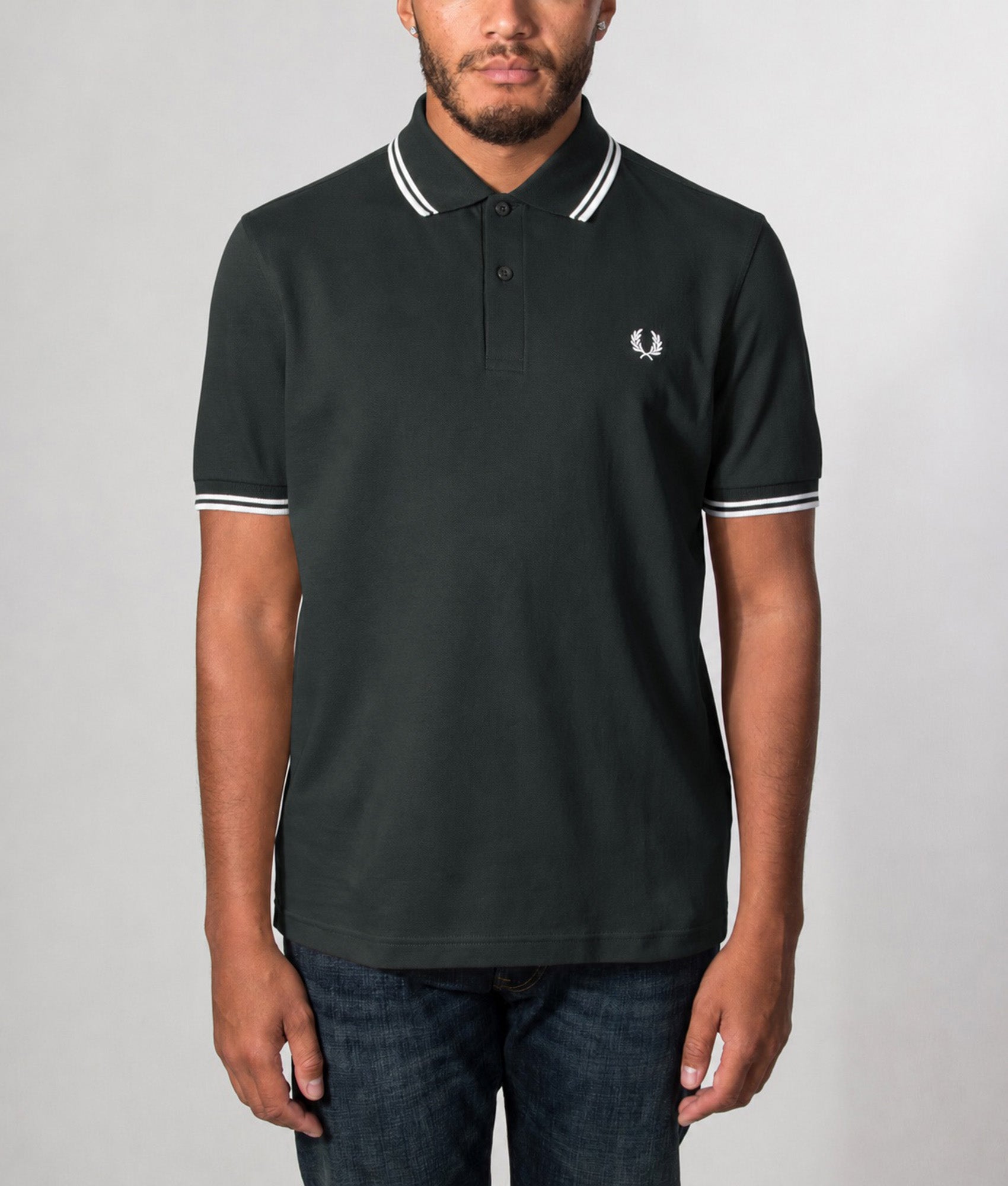 Fred Perry Twin Tipped Polo Shirt in Night Green and Snow White at EQVVS Menswear. Model front shot.