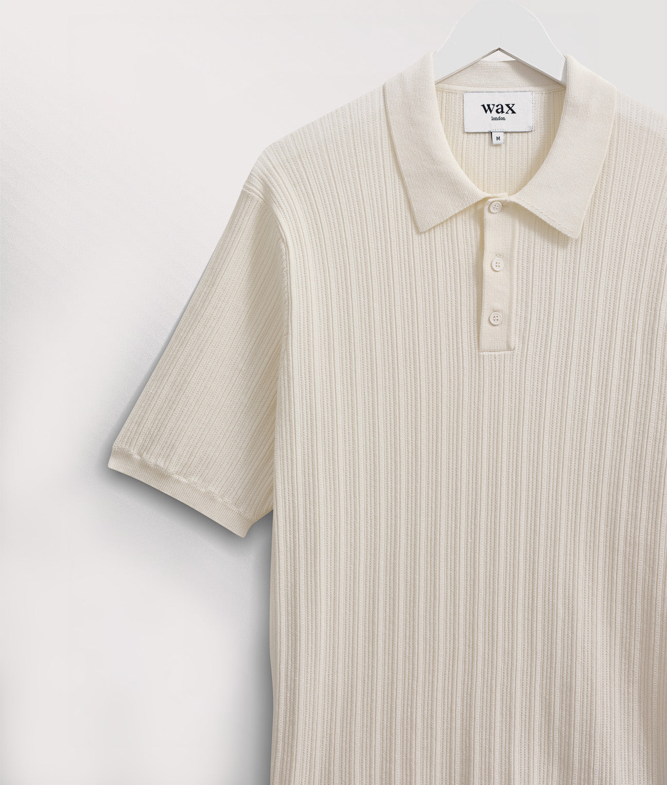 Wax London Naples Polo Shirt in Ecru at EQVVS. Angle Shot Hanger.