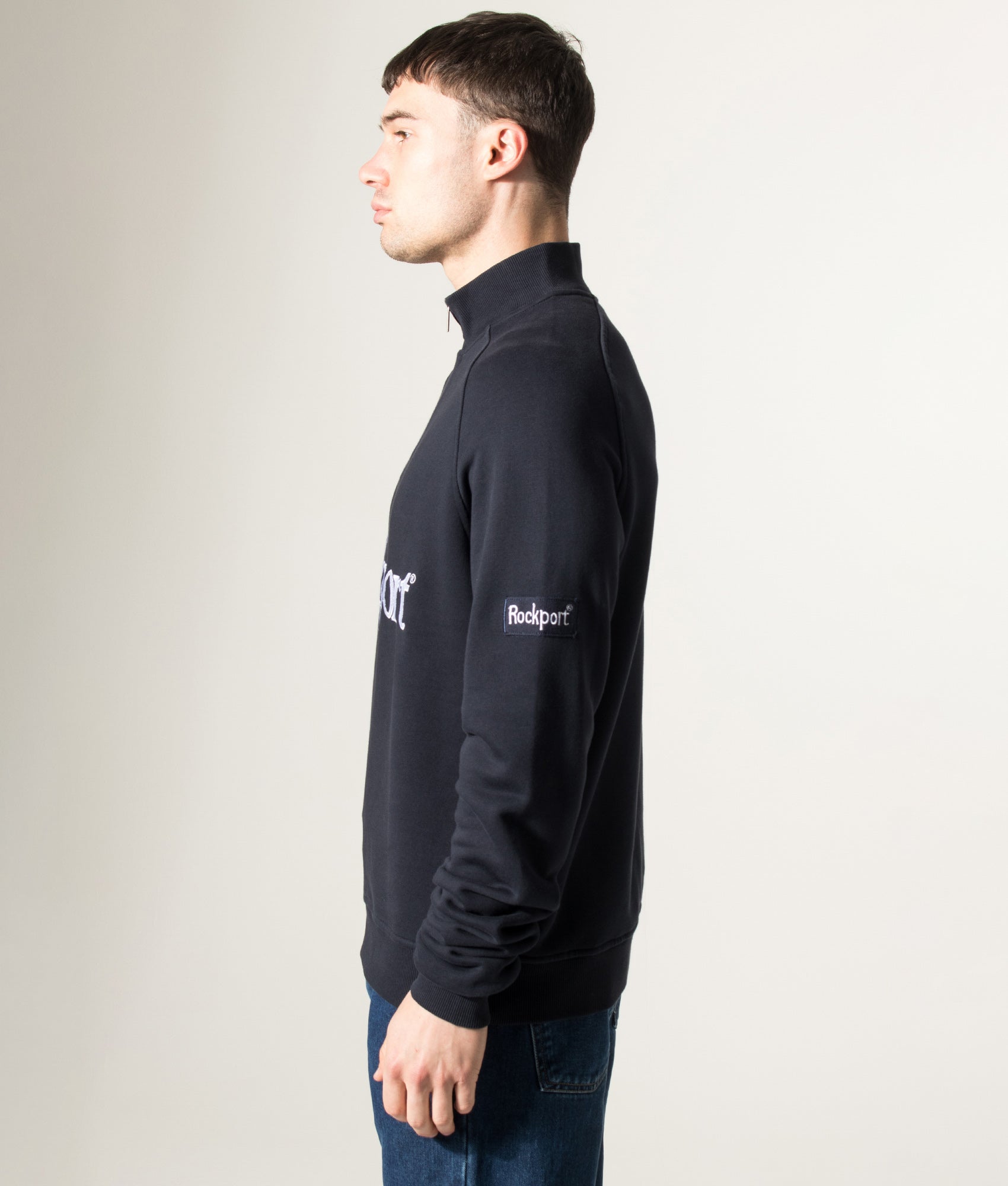 Rockport Relaxed Fit Boston Logo Quarter Zip Sweatshirt in Navy at EQVVS Menswear. Model side shot.