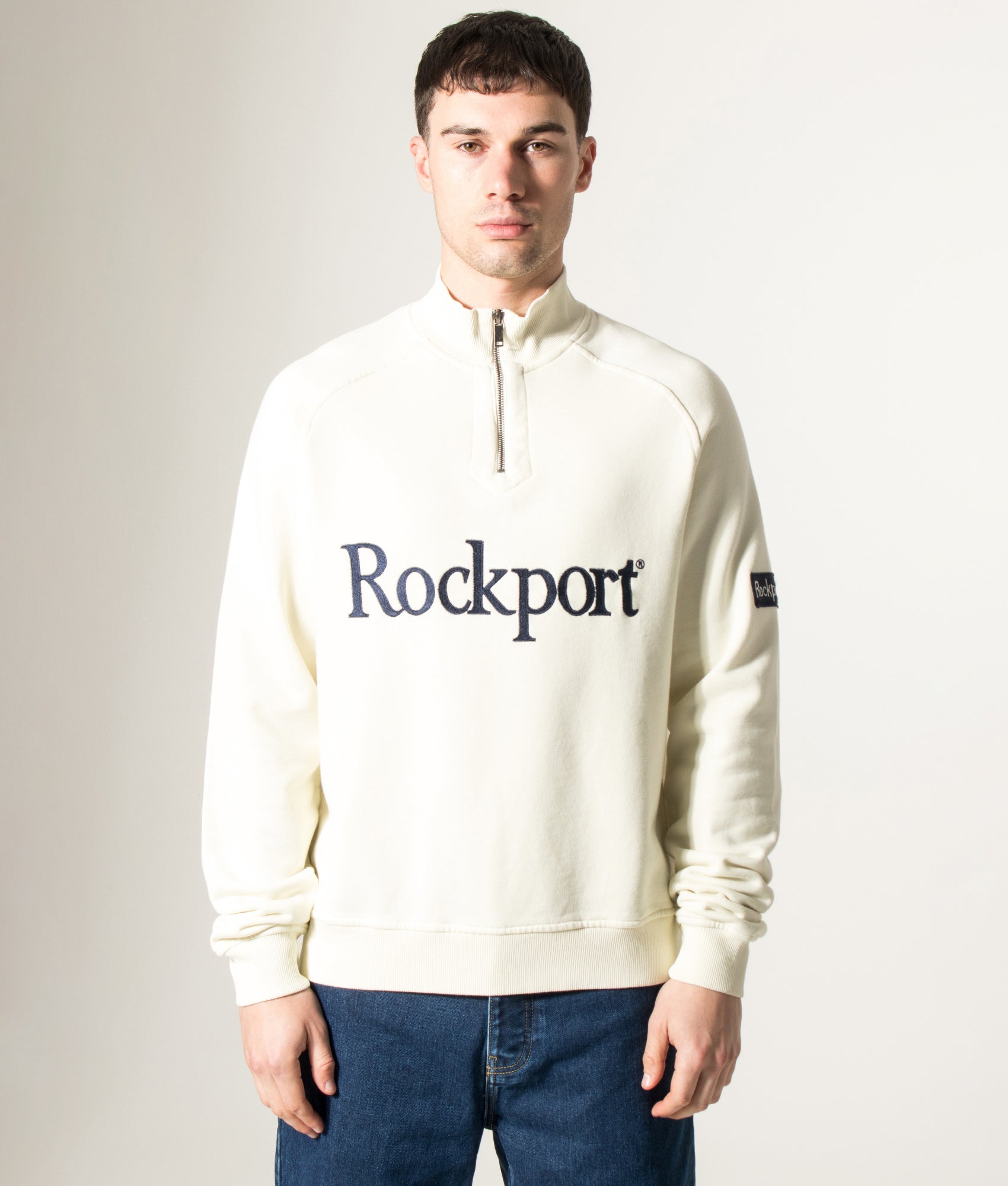 Rockport Relaxed Fit Boston Logo Quarter Zip Sweatshirt in Ecru at EQVVS Menswear. Model front shot.