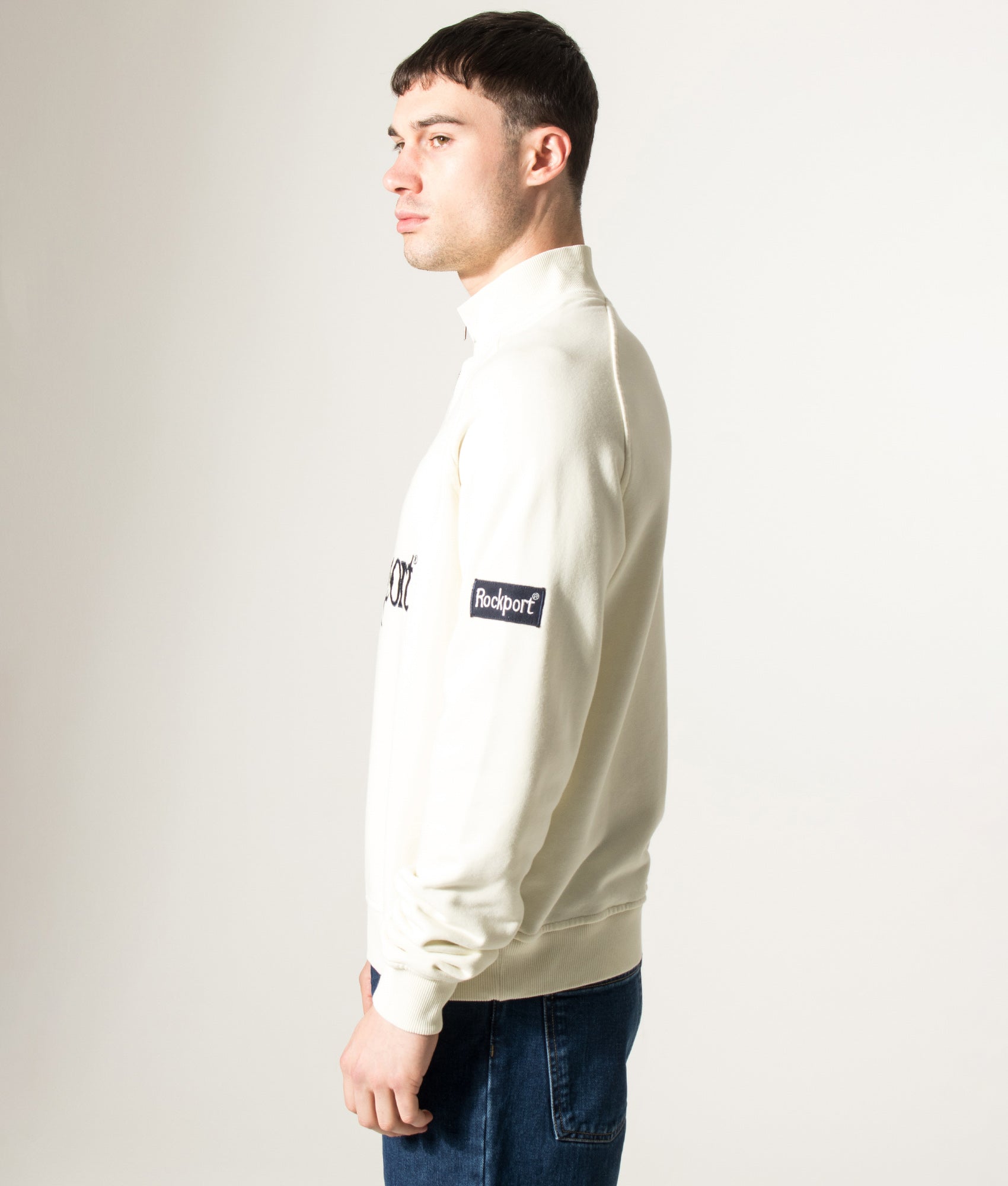 Rockport Relaxed Fit Boston Logo Quarter Zip Sweatshirt in Ecru at EQVVS Menswear. Model side shot.