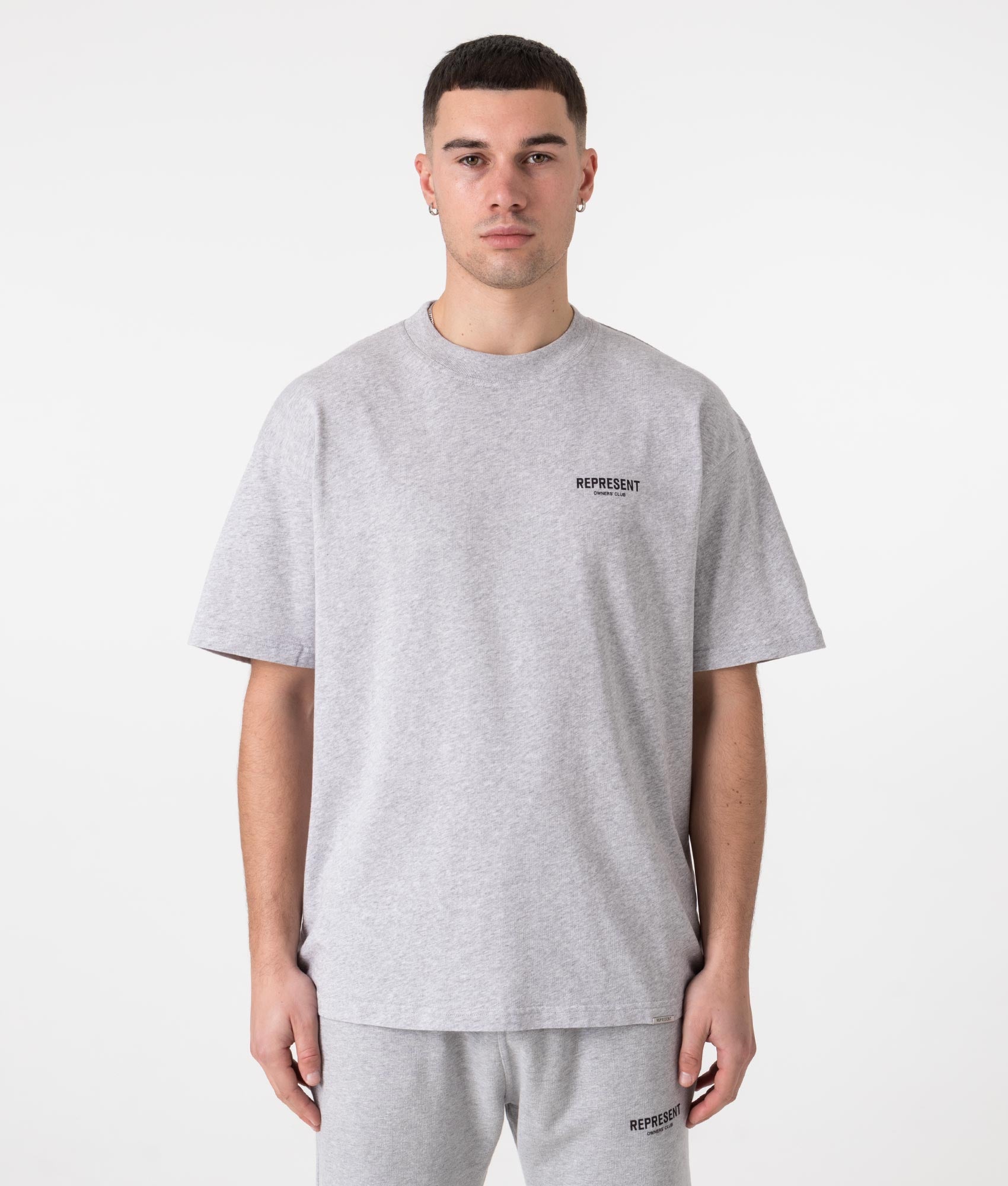 Represent Oversized Fit Owners Club T-Shirt in Grey at EQVVS Menswear. Model front shot.