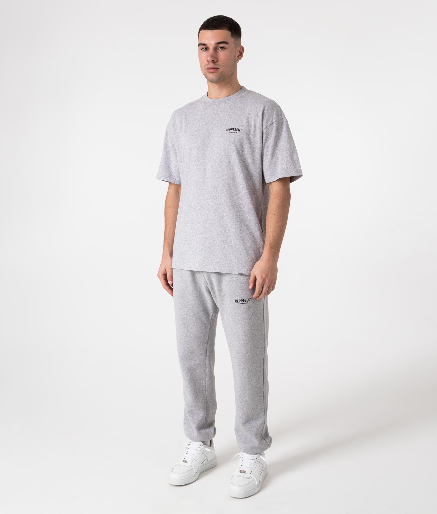 Represent Oversized Fit Owners Club T-Shirt in Grey at EQVVS Menswear. Model full body shot.