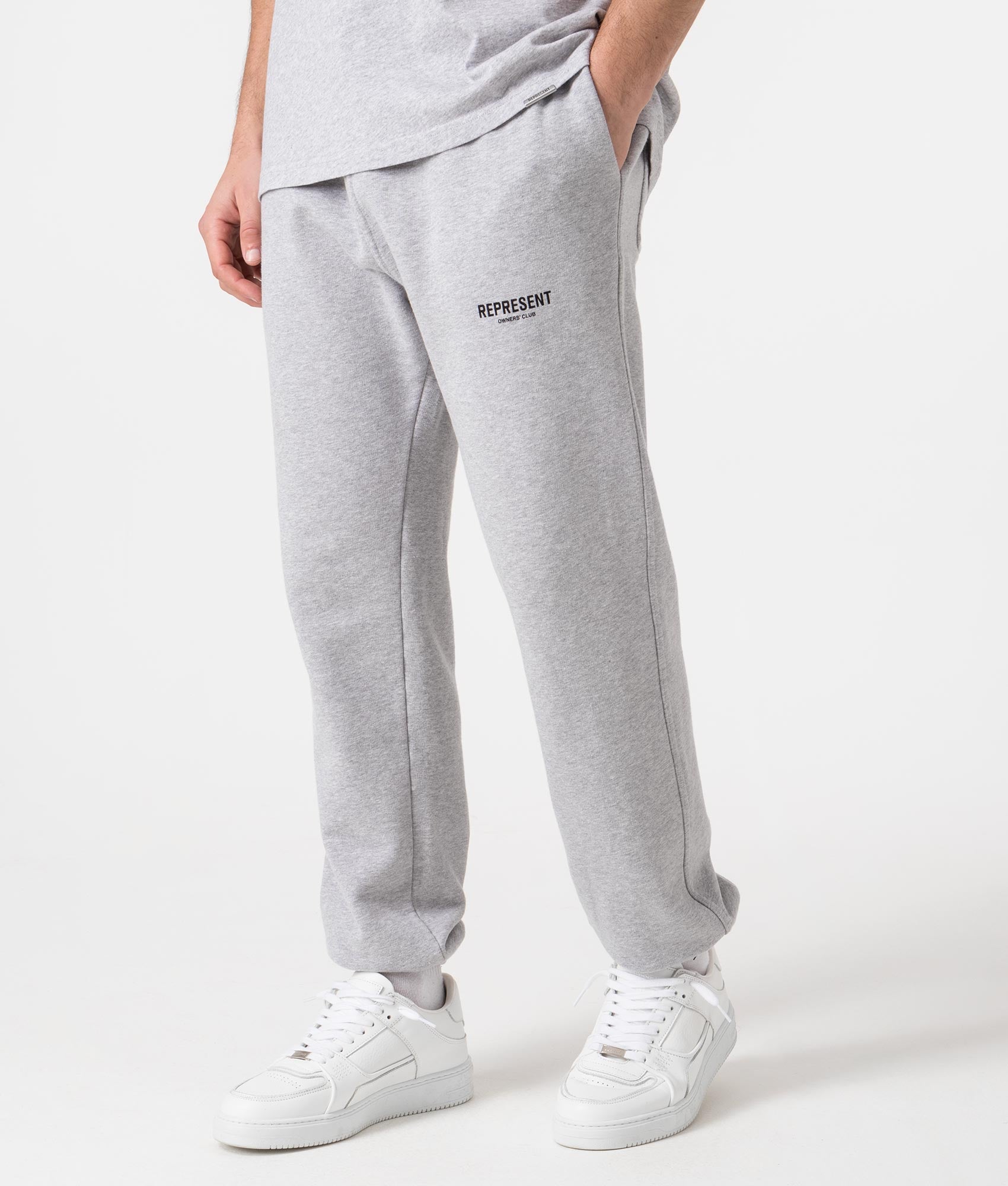 REPRESENT Owners Club Joggers in Ash Grey at EQVVS Menswear. Angled model front shot.