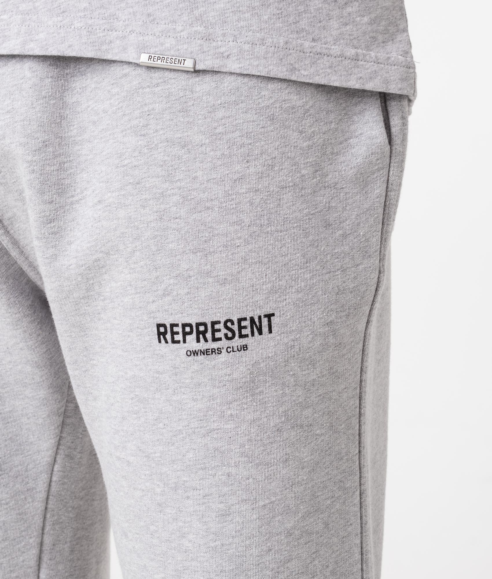 REPRESENT Owners Club Joggers in Ash Grey at EQVVS Menswear. Model detail shot.