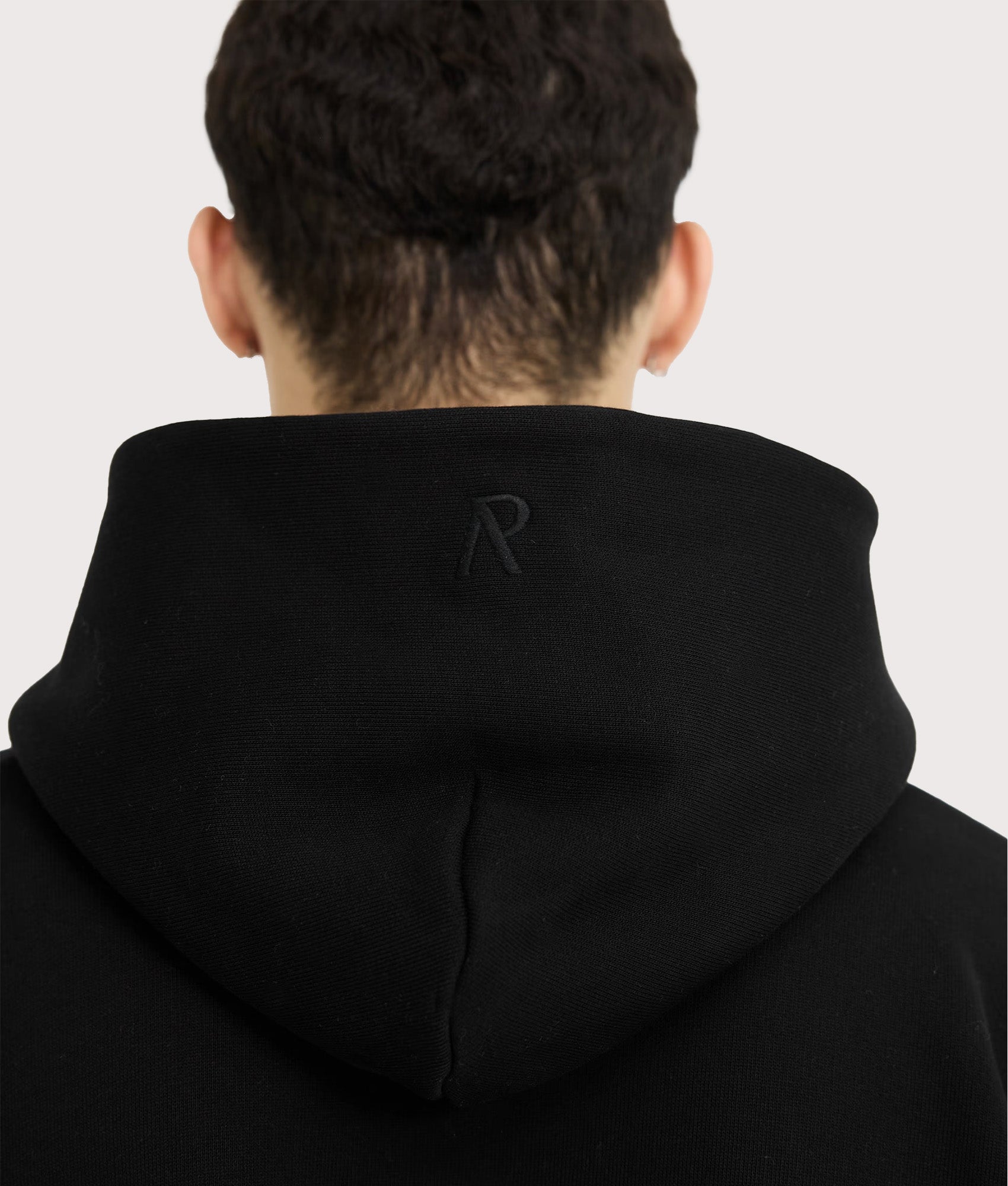 REPRESENT Initial Boxy Oversized Hoodie in black at EQVVS Menswear. Hood detail shot. 