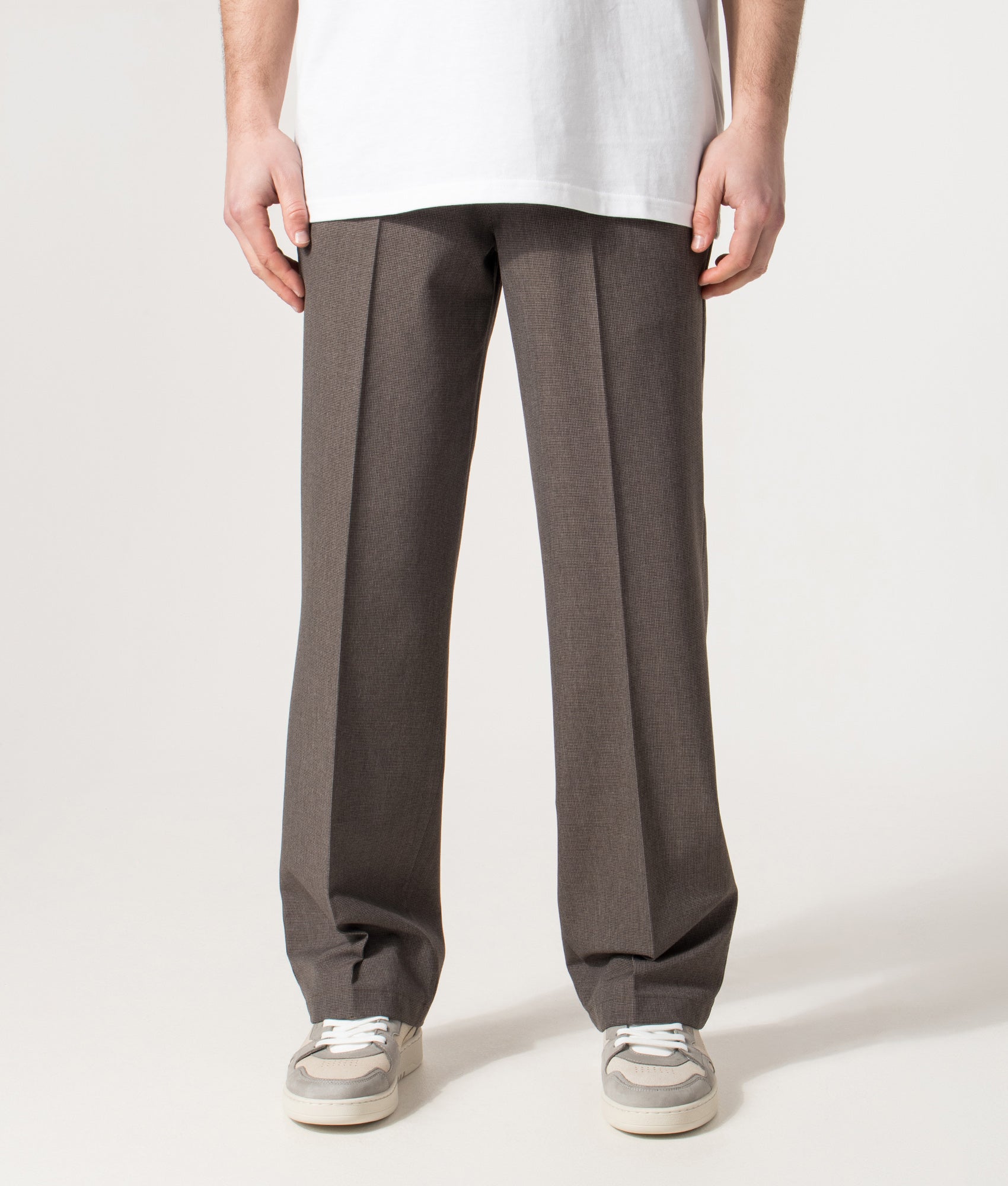 Wax London Bayham Trousers in Brown Micro Puppytooth at EQVVS Menswear. Model front shot.