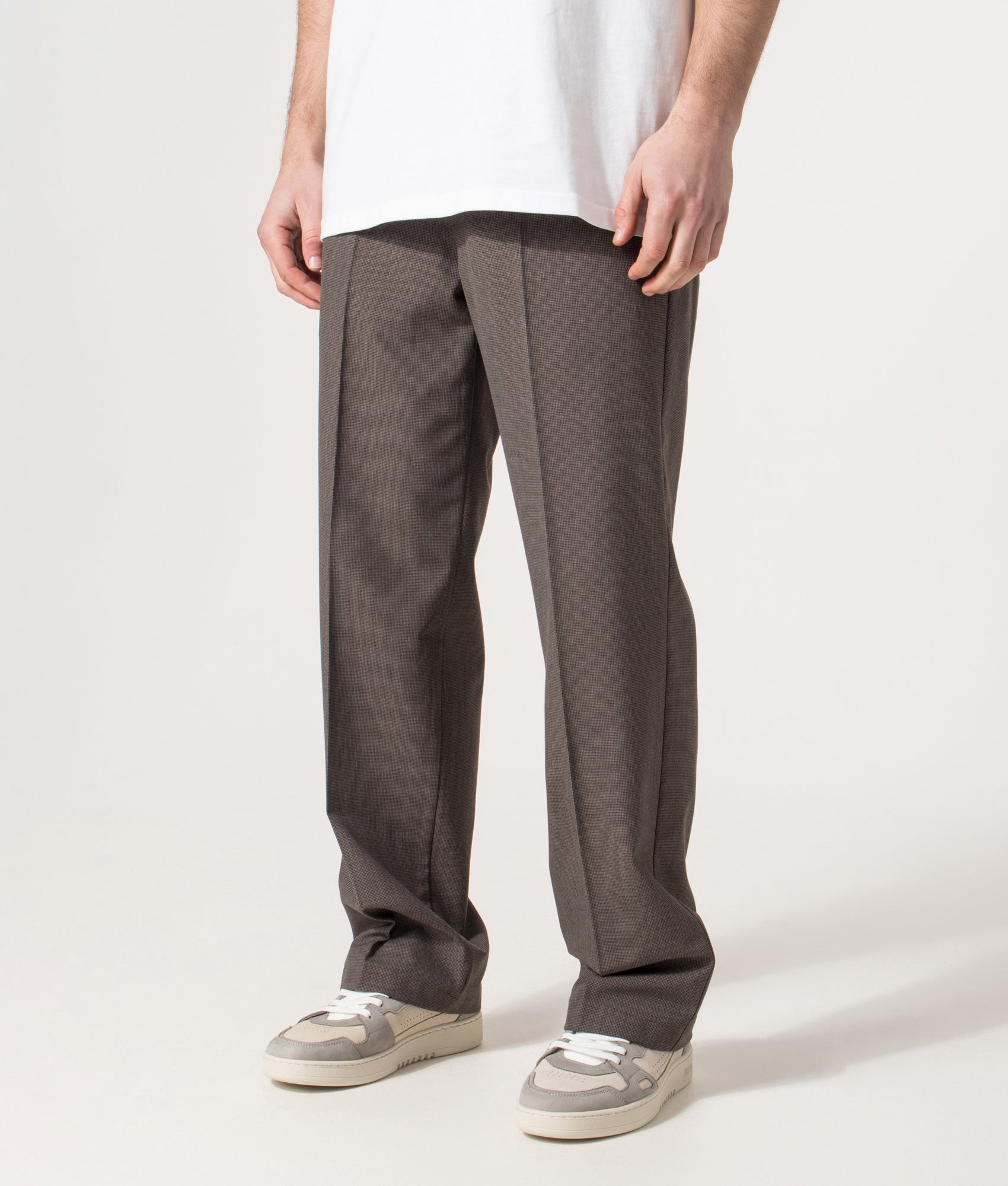 Wax London Bayham Trousers in Brown Micro Puppytooth at EQVVS Menswear. Angled model front shot.