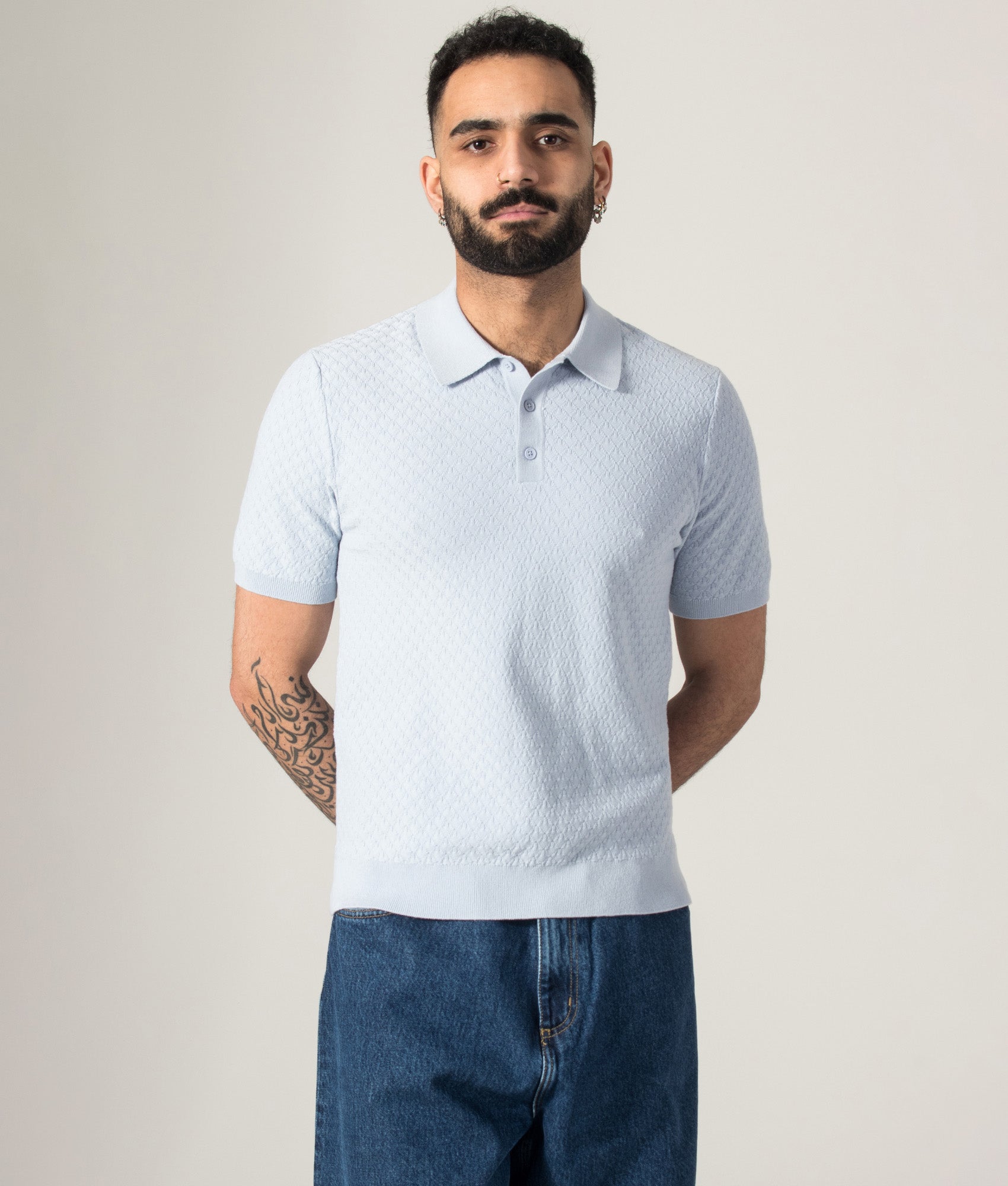Wax London Naples Retro Diamond Polo Shirt in Pale Blue at EQVVS Menswear. Model front shot.