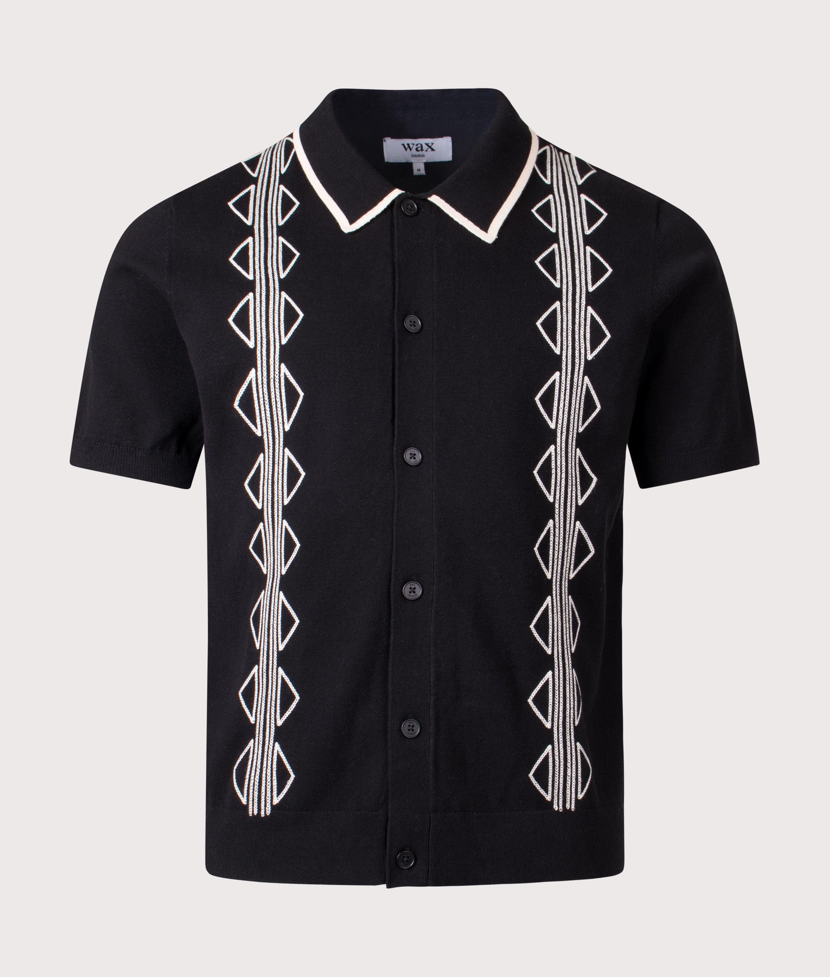 Tellaro Retro Embroidery Polo Shirt in Black/Ecru by Wax London. Shot by EQVVS. Front shot.